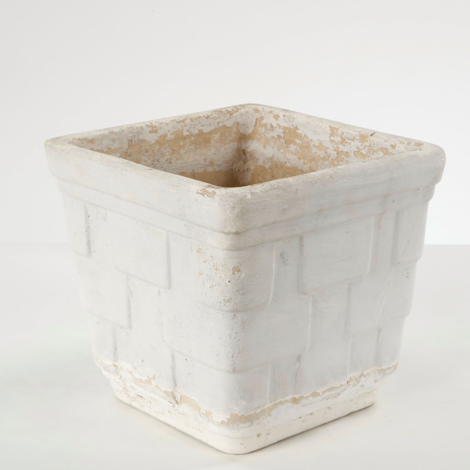 Square Concrete Planter, 1960s: Cast in concrete with a restrained geometric profile, this square planter features subtle relief detailing and a softly weathered surface. Its clean proportions and natural patina exemplify mid-centur