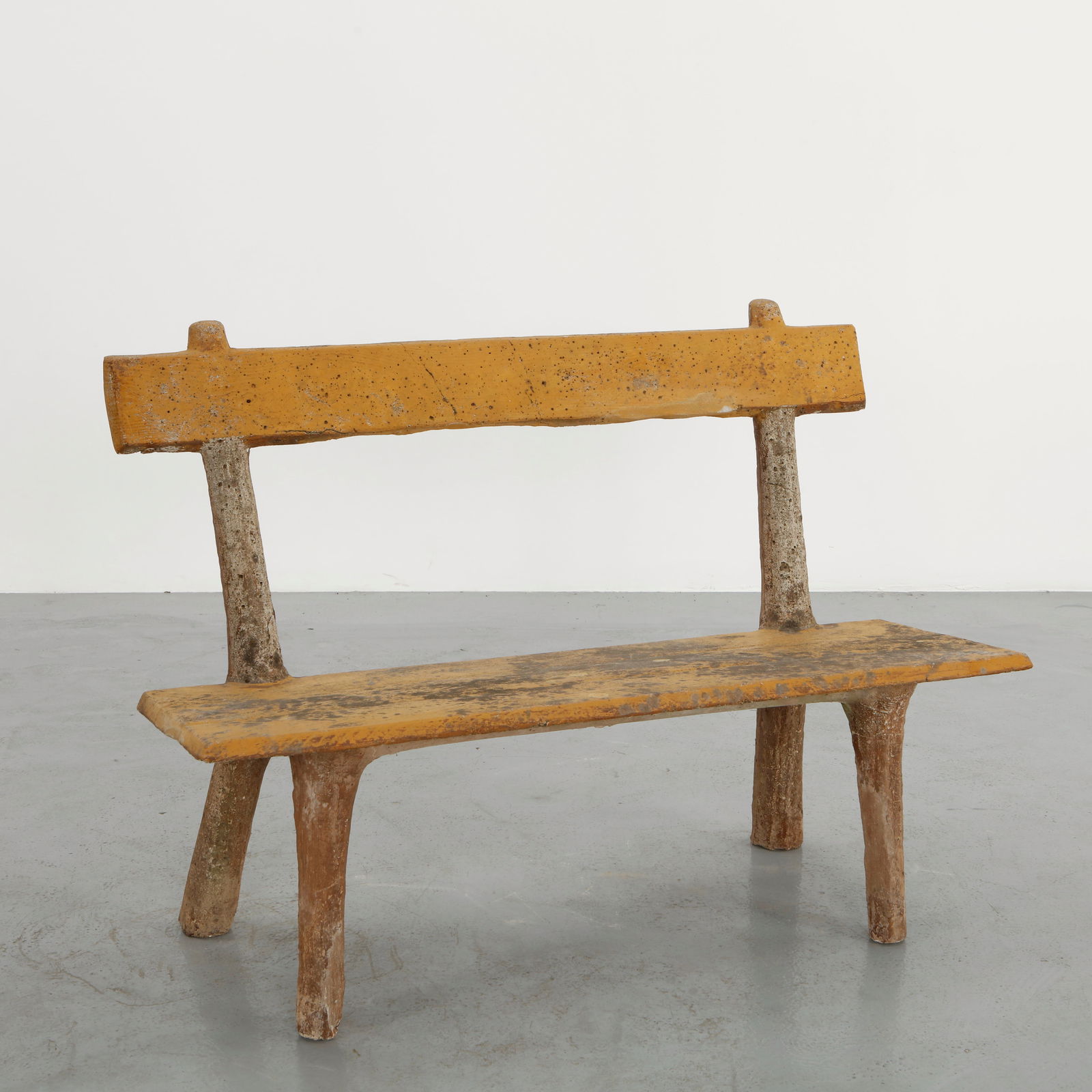 French Faux Bois Garden Bench, 1960s: Garden bench in cast concrete executed in the traditional faux bois technique. The sculpted structure supports a long seat and backrest with beautifully aged surfaces. A sculptural outdoor piece celeb