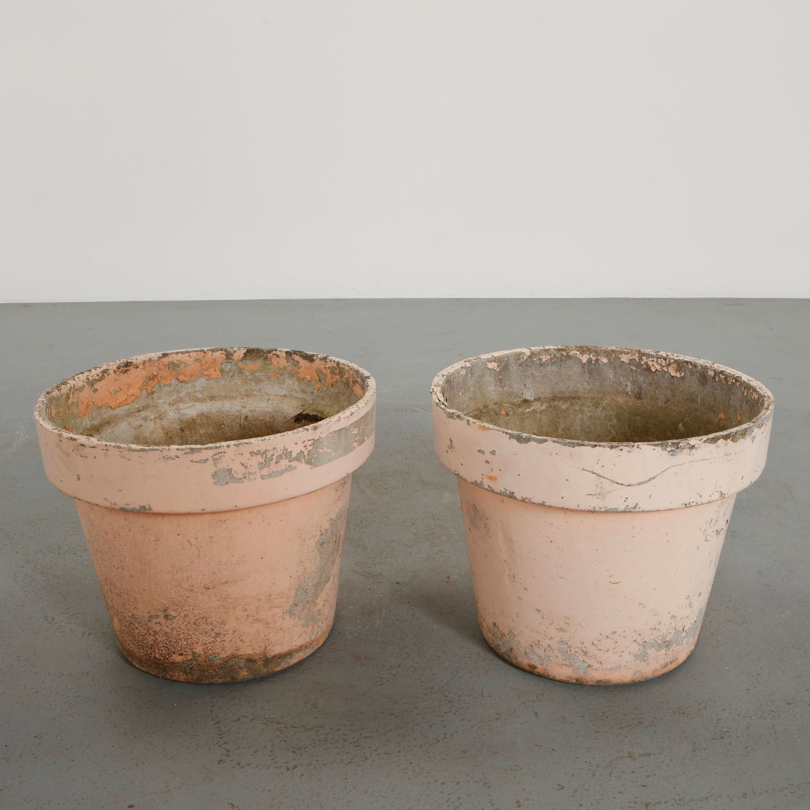 Willy Guhl, Pair of Round Planters, 1960s: Executed in fiber cement with softly curved silhouettes. These planters exemplify Guhl approach to functional sculptural outdoor design. Naturally aged surfaces enhance their sculptural quality.