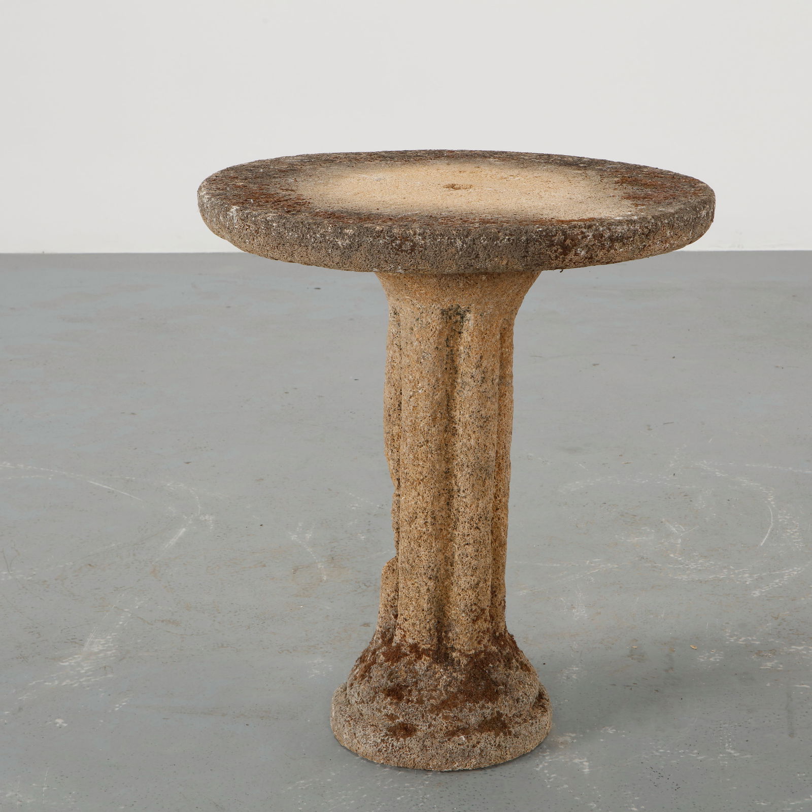 Stone Outdoor Side Table, 1960s: Carved from solid stone, this sculptural side table features a circular top raised on a monolithic pedestal base. The mineral surface reveals a richly textured patina, shaped by time and use. A