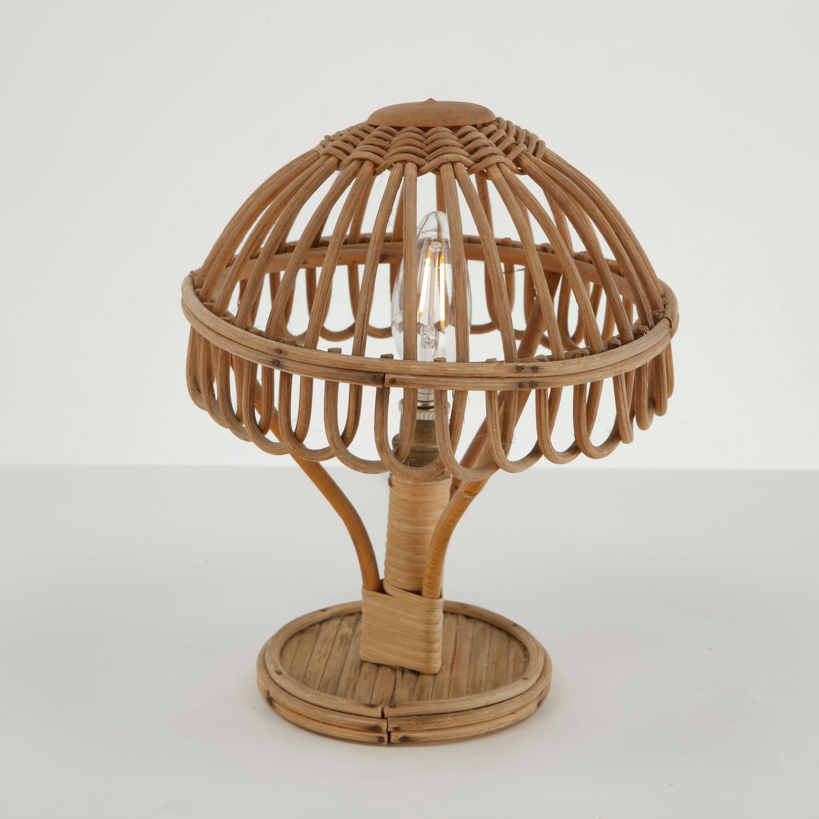 Louis Sognot, Bamboo Table Lamp, France, 1950s: Executed in bent bamboo and woven rattan, this table lamp features a domed openwork shade composed of finely curved bamboo elements surrounding the exposed bulb. The sculptural base with wrapped