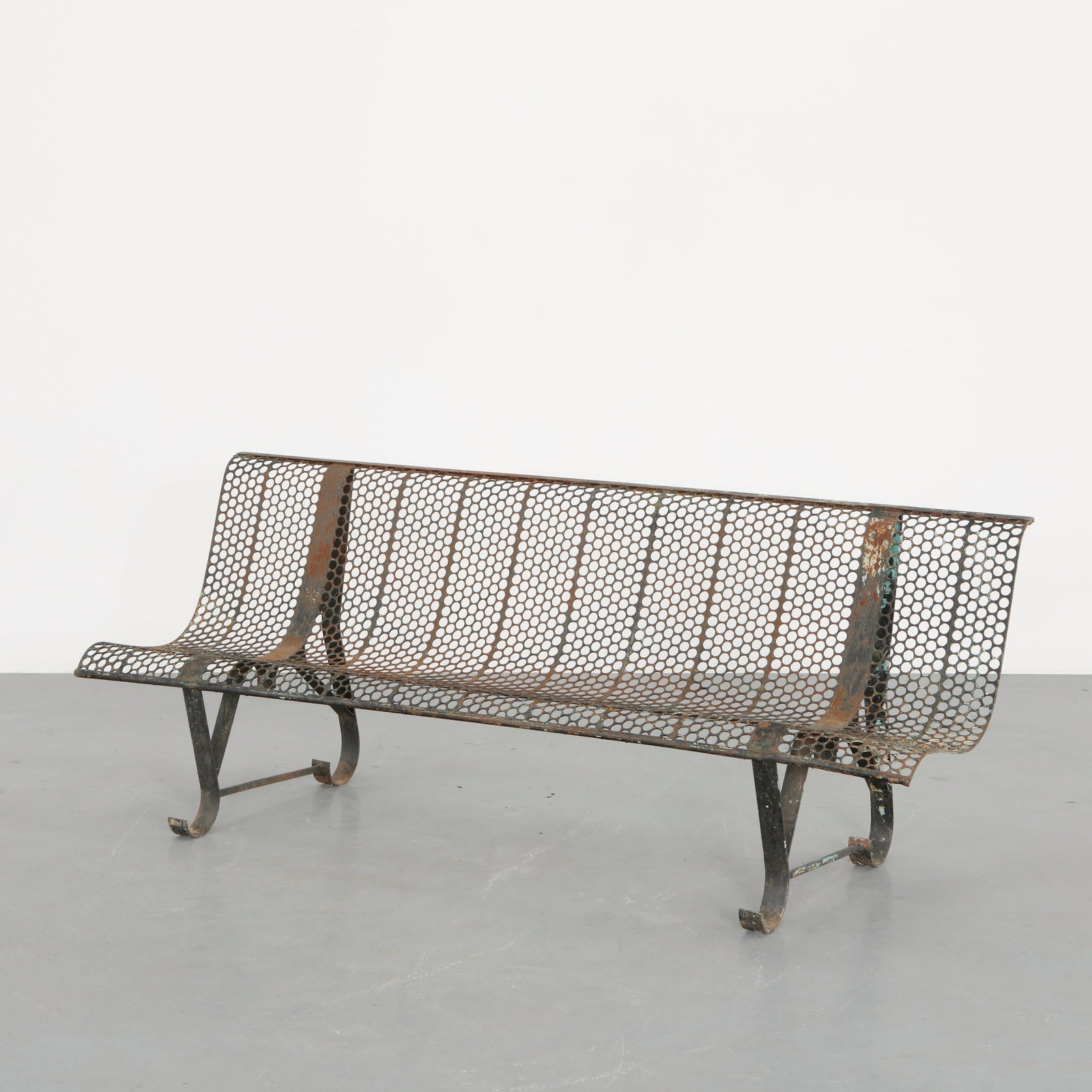 Rene Malaval, Perforated Metal Bench, 1950s: Constructed in perforated sheet metal forming a continuous curved seat and backrest. The rhythmic grid of circular perforations creates a light visual texture while ensuring durability for outdoor use