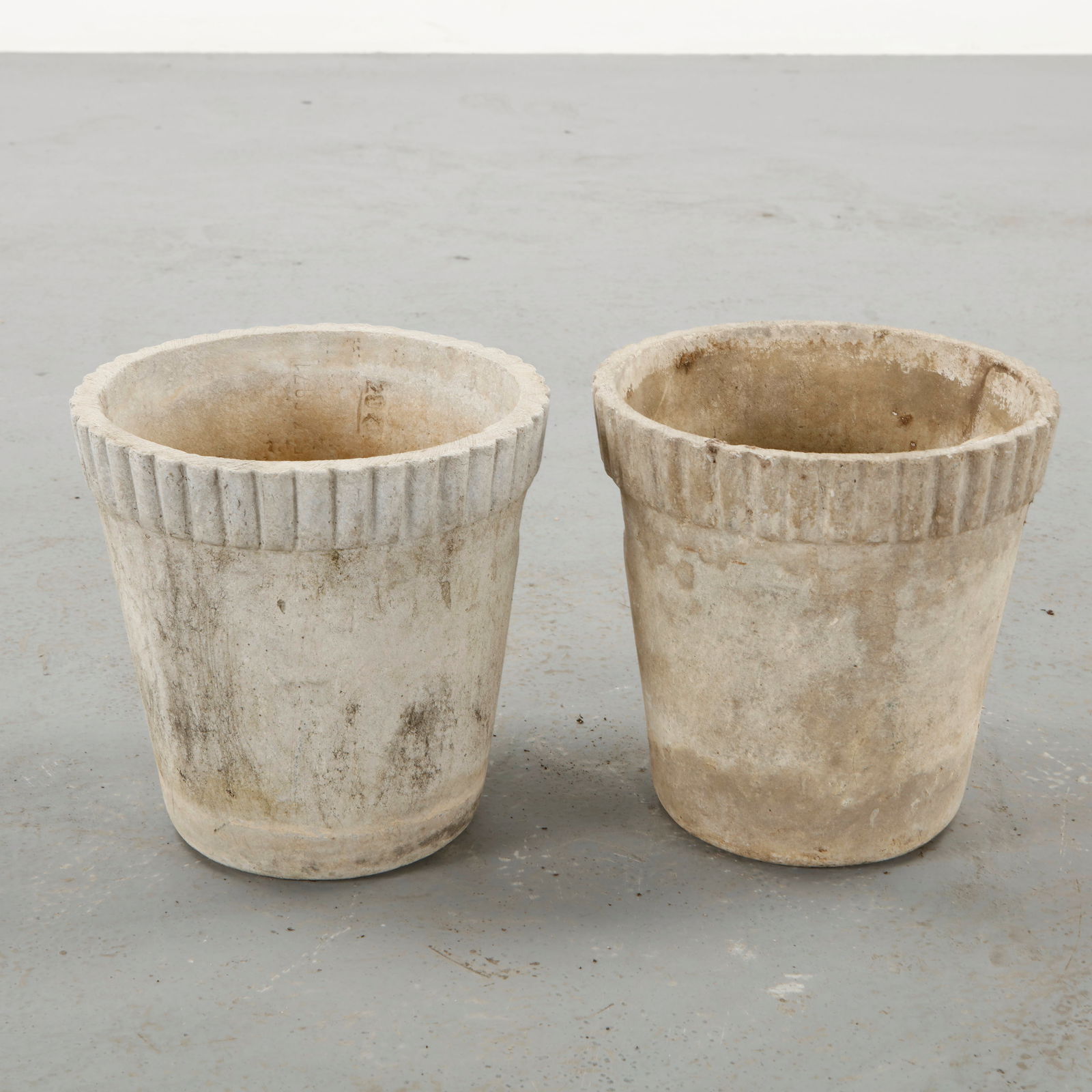 Willy Guhl, Pair of Round Planters, 1960s: Pair of cylindrical planters designed by Willy Guhl and produced by Eternit in fiber cement. The simple rounded form reflects the designer focus on essential geometry and material honesty. Their
