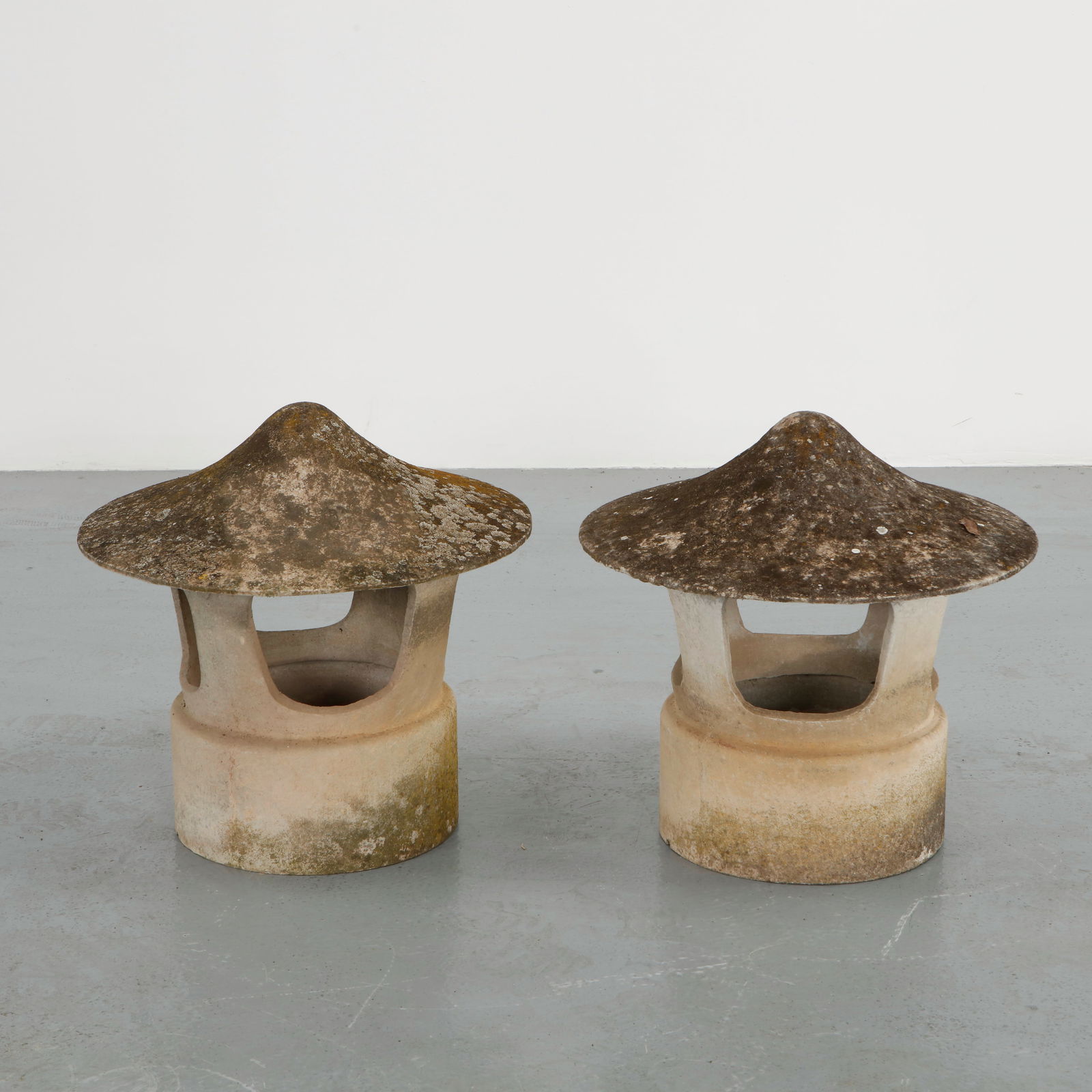 Willy Guhl, Pair of Concrete Chimney Tops, 1960s: Pair of sculptural concrete chimney caps featuring broad domed canopies supported by cylindrical bases. The surfaces display a naturally weathered patina developed through years of outdoor exposure.