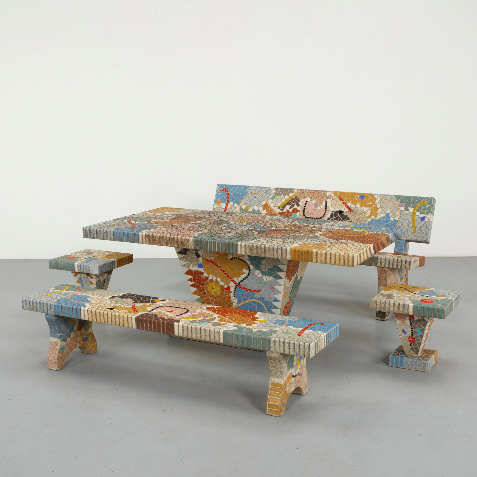 Polychromatic Mosaic Tile Garden Dining Set, 1950s: Executed in tessellated ceramic mosaic over a sculptural base, this garden exceptional ensemble features a richly composed tabletop with abstract figural and geometric motifs. The hand-set tesserae re