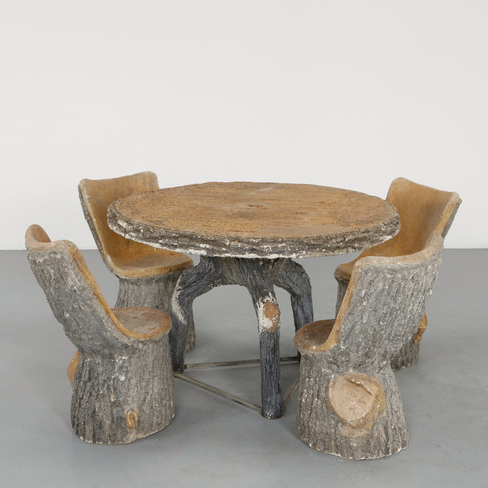 Lind Lenz, Faux Bois Dining Set, 1960s: A stunning and extremely rare outdoor dining ensemble executed in sculptural concrete, featuring a circular table supported by branching legs and four armchairs carved in a trunk-like form. The surfac