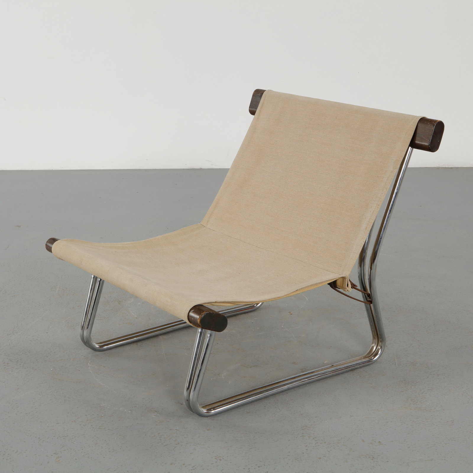 Scandinavian Modern Canvas and Chrome Sling Chair, 1960s: Constructed with a chromed tubular frame and suspended canvas seat, this sling chair embodies the lightness and functionality of Scandinavian modern design. The tensioned textile creates a relaxed sea