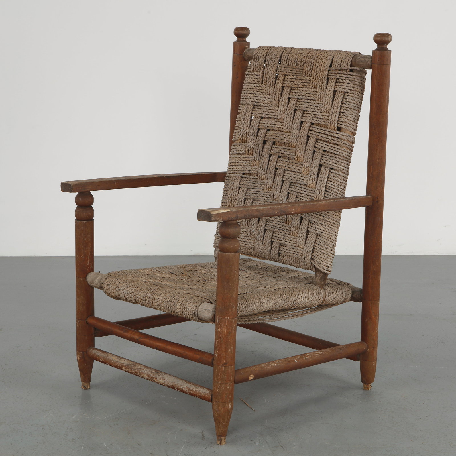 Rope and Wood Armchair attributed to Charles Dudouyt, 1950s: Armchair crafted in solid wood with woven rope seat and back, reflecting Dudouyt distinctive rustic modernism. The geometric weaving contrasts with the sturdy frame, creating a balanced and tactile