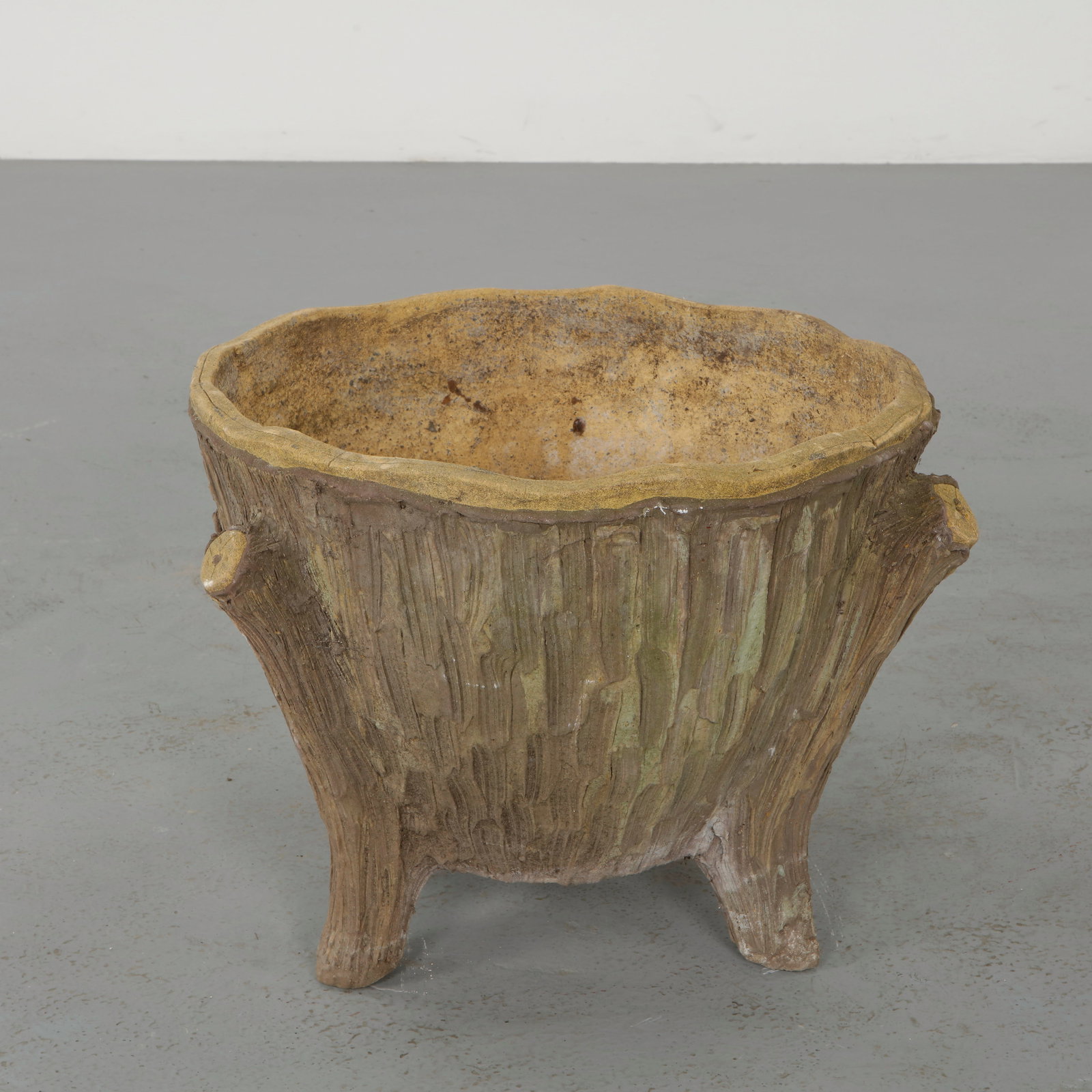 Faux Bois Concrete Planter, 1960s: Modeled to imitate natural wood, these sculptural planters showcase detailed texture and organic form. The hand finished surfaces exhibit a nuanced patina, reinforcing their rustic charm. A
