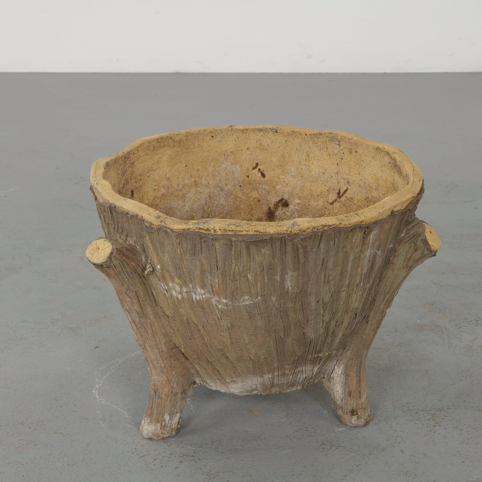 Faux Bois Concrete Planter, 1960s: Modeled to imitate natural wood, these sculptural planters showcase detailed texture and organic form. The hand finished surfaces exhibit a nuanced patina, reinforcing their rustic charm. A decorative