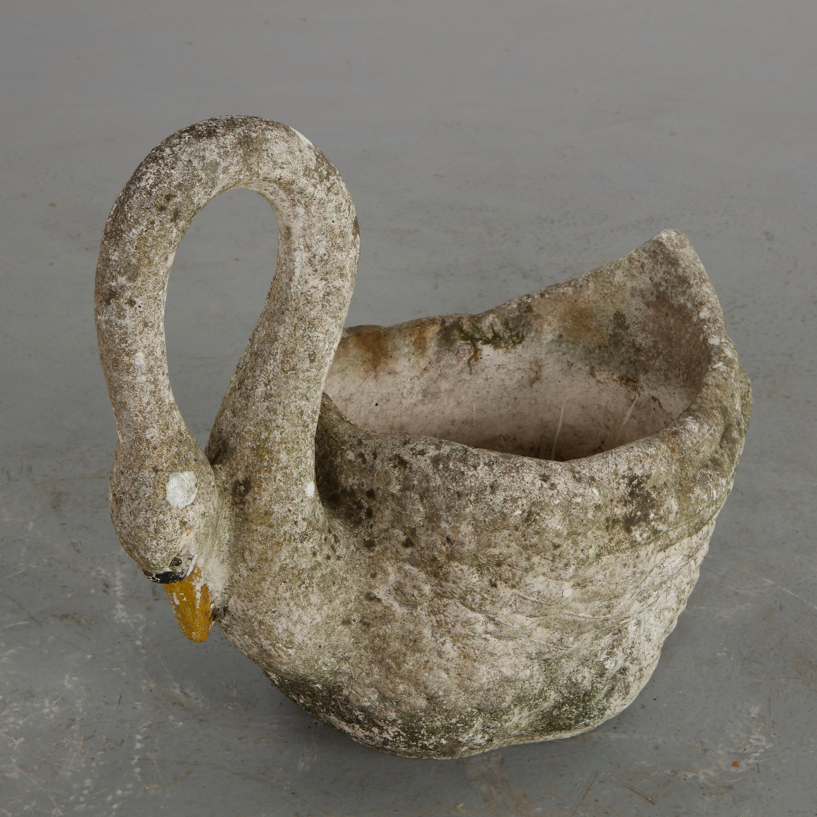 Concrete Swan Planter, 1960s: A sculptural planter formed as a swan, executed in cast concrete with a generous basin. The aged surface and natural weathering lend character and authenticity to the piece. Height: 20 in. Width: 24 i