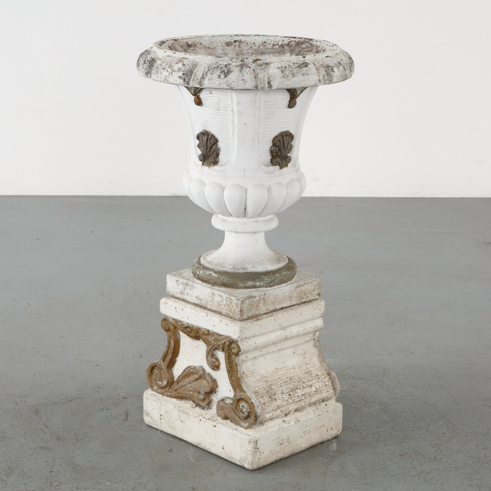 Italgarden, Stone Urn Planter on Stand, 1950s: Classical urn in cast stone raised on an integral pedestal base, adorned with molded decorative motifs. The weathered surface lends authenticity and elegance to this traditional garden form. Height: 3