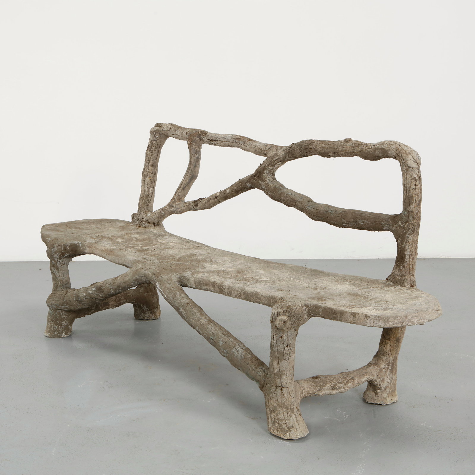 Monumental Faux Bois Concrete Bench, 1960s: A stunning and highly sculptural bench crafted in faux bois concrete, faithfully imitating the texture and irregularity of natural branches. The elongated seat is supported by intricately formed legs