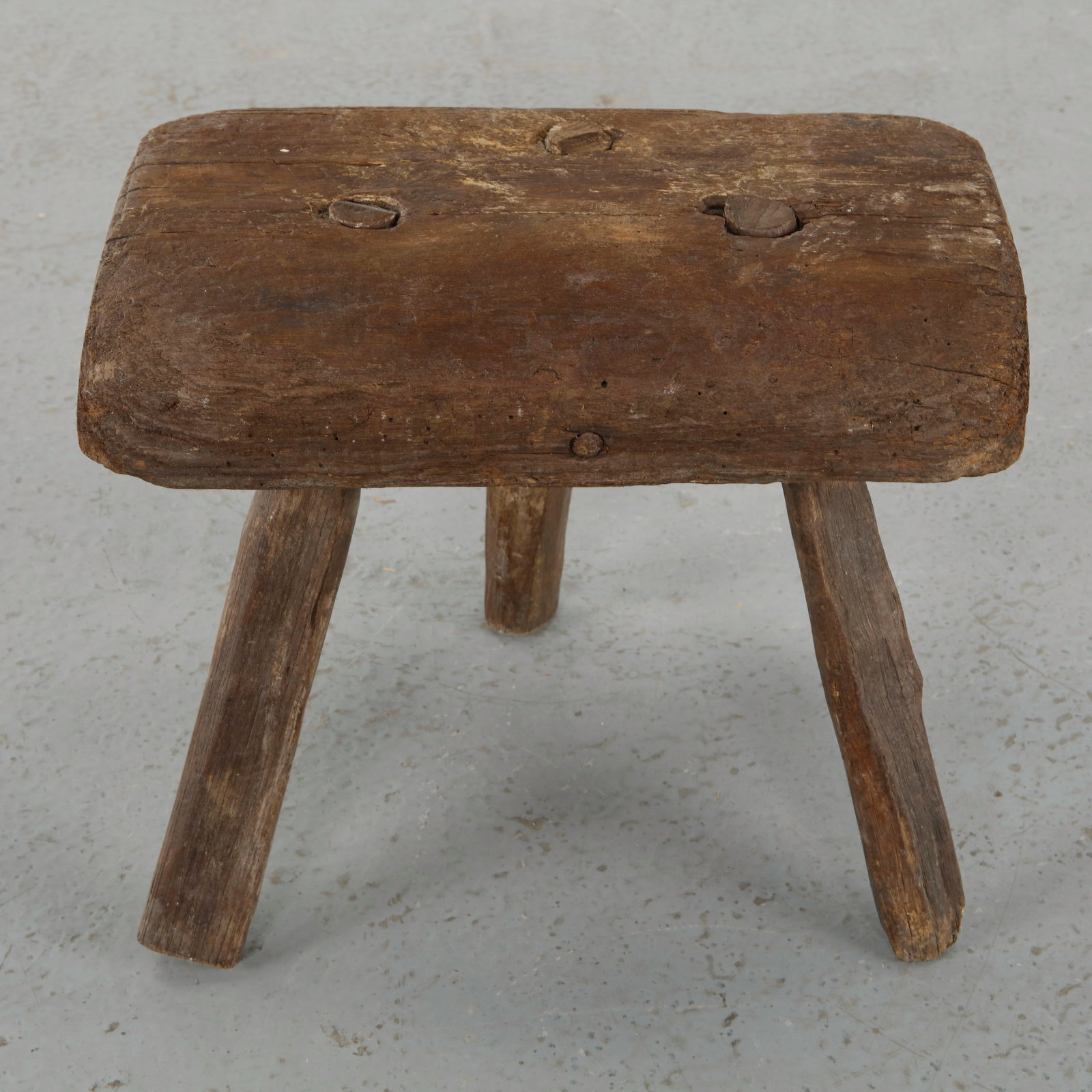 Brutalist Tripod Stool, 1960s: Tripod stool in solid wood featuring a thick circular seat and robust legs, expressing a raw and sculptural Brutalist aesthetic. The visible grain and hand finished surfaces emphasize its artisanal ch