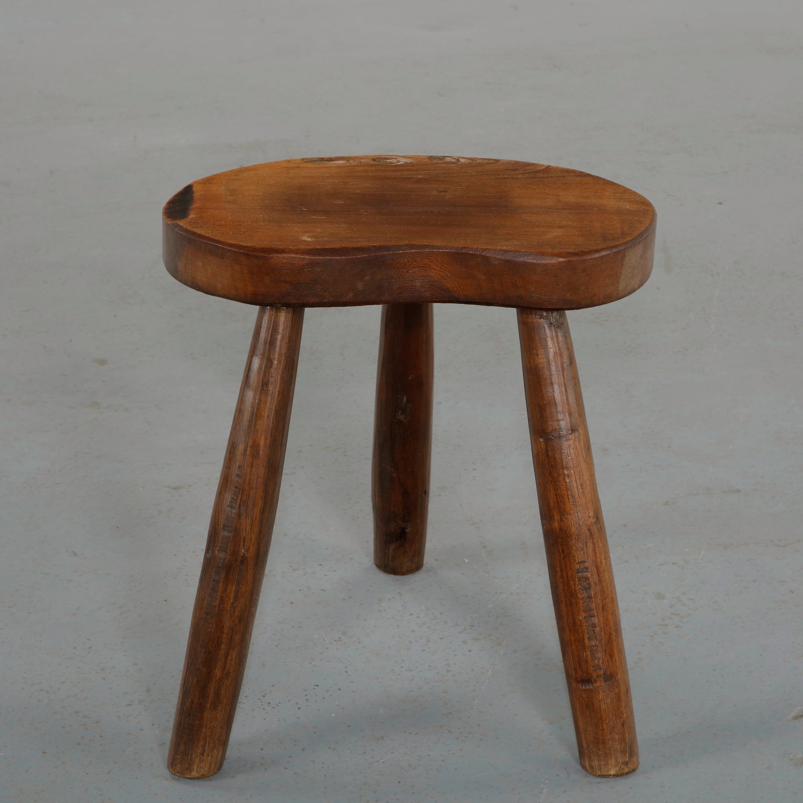 Brutalist Tripod Stool, 1960s: Compact stool with a thick circular seat and three tapered legs. The deeply aged patina and simple geometry highlight the strength of its rustic brutalistÂ design. Height: 16.5 in. Width: 13.5 in. De