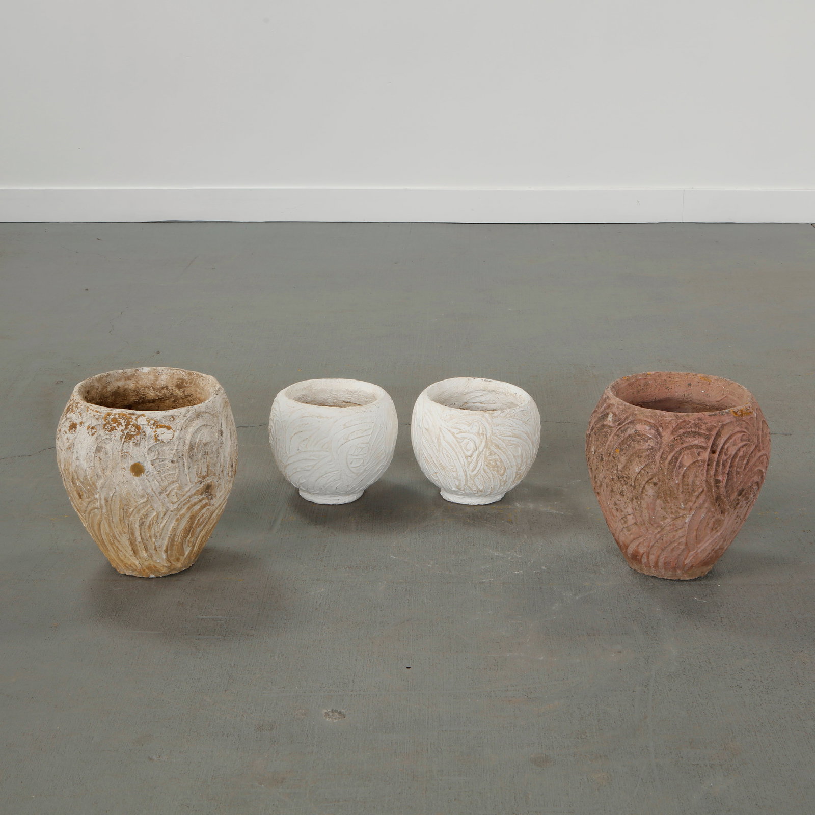 Set of Four Concrete Planters, 1960s: Group of four concrete planters with hand-worked surfaces and varied mineral patina. A cohesive ensemble illustrating the organic decorative language of the period. Smaller: Height: 7.8 in. Diameter: