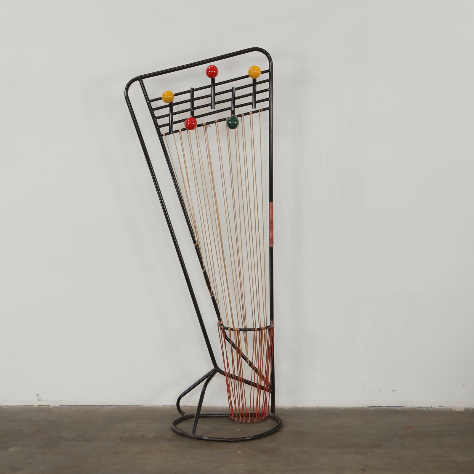 Roger Feraud, Atomic Hall Stand, 1960s: Executed in wrought metal with lacquered spherical accents, this hall stand displays the playful graphic energy of French atomic era design. The slender rods and vibrant colors create a dynamic sculpt