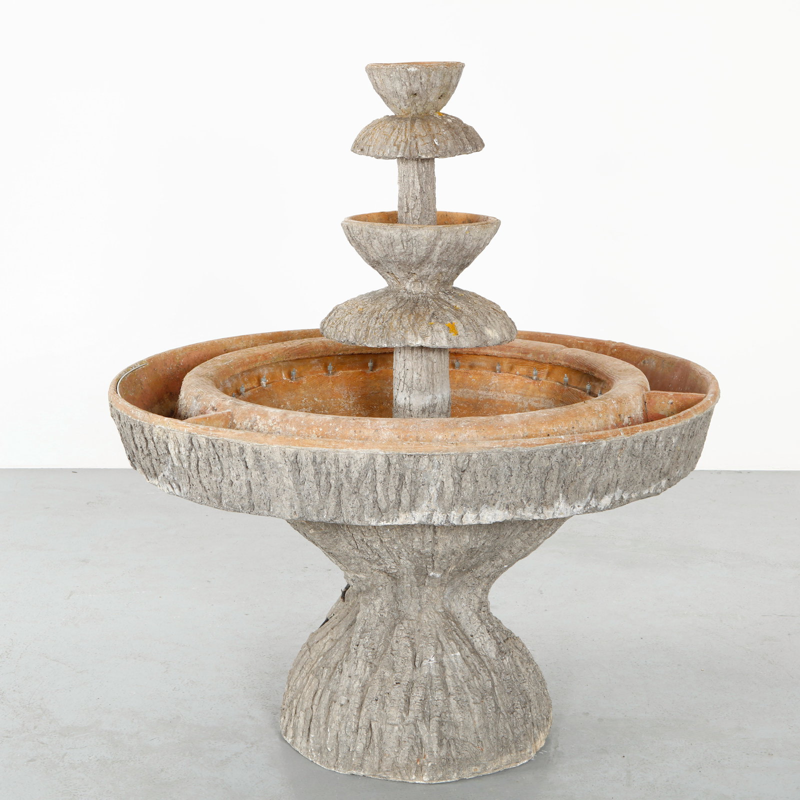 Monumental Faux Bois Fountain, 1960s: Executed in molded concrete with a bark-like texture, this multi-tier garden fountain reflects the organic vocabulary of faux bois craftsmanship. The stacked basins and sculptural form create a striki