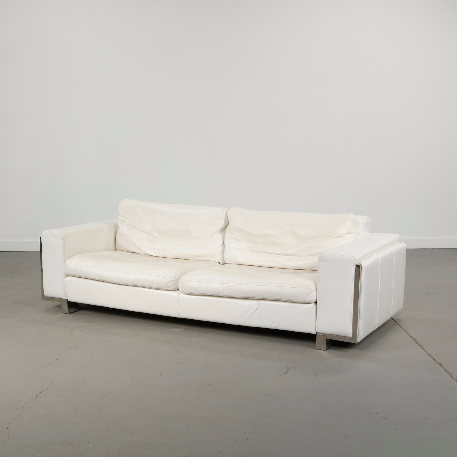 Roche Bobois, Cream Three-Seater Leather Sofa, 2000s: Generously proportioned sofa executed in cream leather with deep cushioning and relaxed silhouettes. Designed for comfort with clean contemporary lines emblematic of Roche Bobois production in the ear
