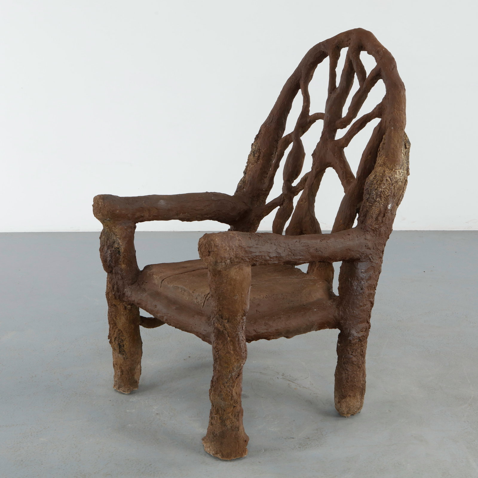 Monumental Faux Bois Scuptural Armchair: Monumental faux bois armchair with organic openwork backrest and heavily textured sculptural surfaces. The expressive silhouette evokes intertwined branches and the romantic spirit of midcentury Frenc