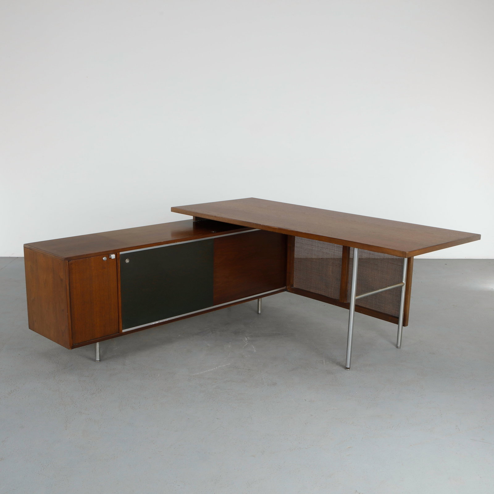 George Nelson for Herman Miller Mahogany Desk, 1970s: Crafted in mahogany with a clean architectural profile and distinctive mesh front panel, reflecting Nelson innovative approach to office design. A functional and elegant executive piece. Height: 30 in