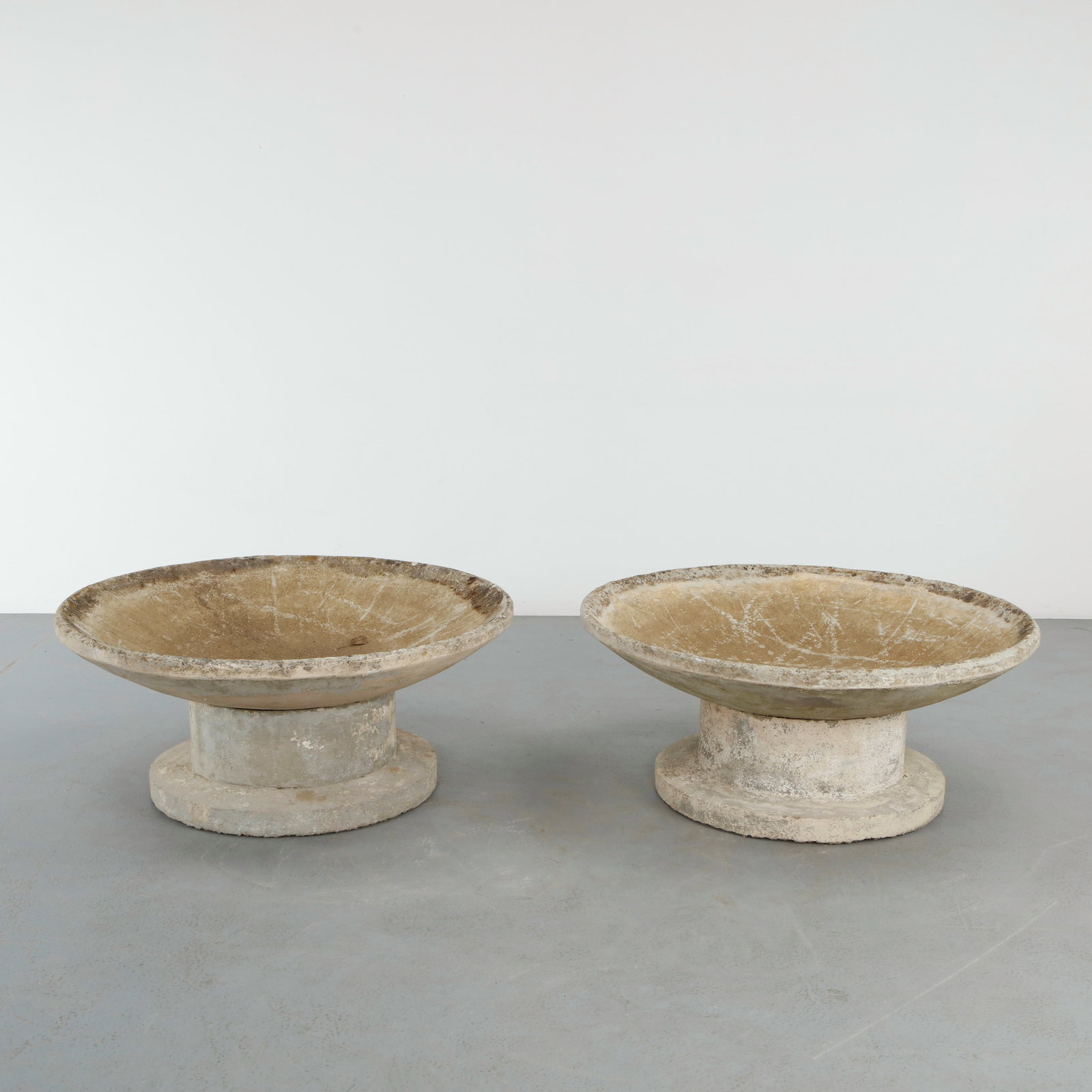 Monumental Pair of Stone Bowl Planters with Stands, 1960s: Monumental pair of stone bowl planters raised on stone pedestal stands with beautifully weathered mineral surfaces. Their restrained sculptural form reflects the purity of classical garden design. Hei