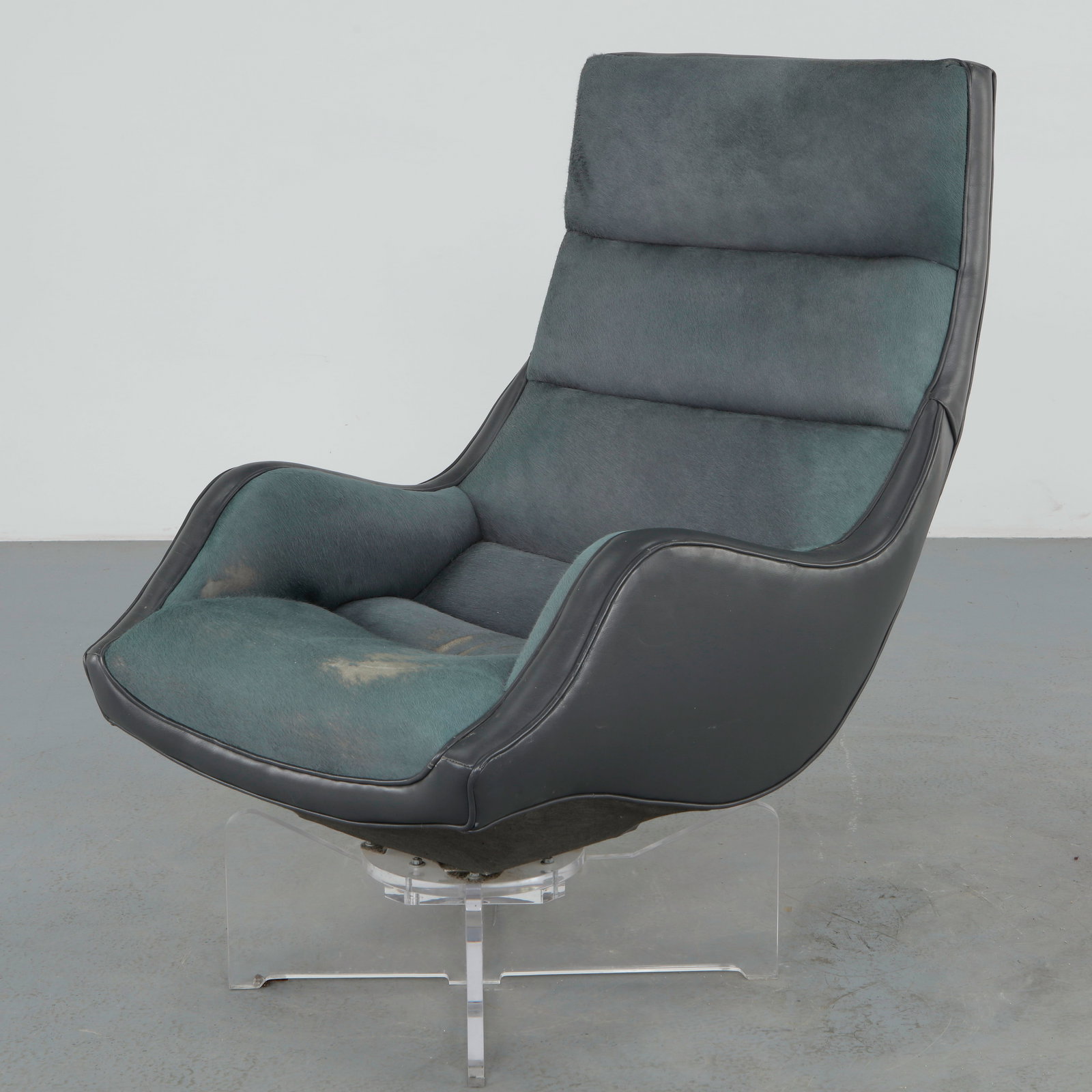 Vladimir Kagan, High Back Contour Swivel Chair ModelÂ 6712 HS on Lucite Base, 1970s: Executed with a sculptural high back form and mounted on a clear lucite swivel base, retaining its original upholstery. A distinctive modernist design offered in as is condition. Height: 41 in. Width: