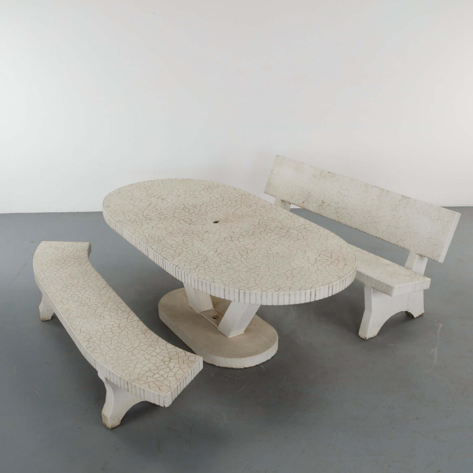 Monumental White Mosaic Tile Dining Set, 1960s: A refined garden set including a round table and two benches, finished with pale mosaic tiles with a subtle geometric texture. The restrained palette highlights the architectural clarity of the form. 