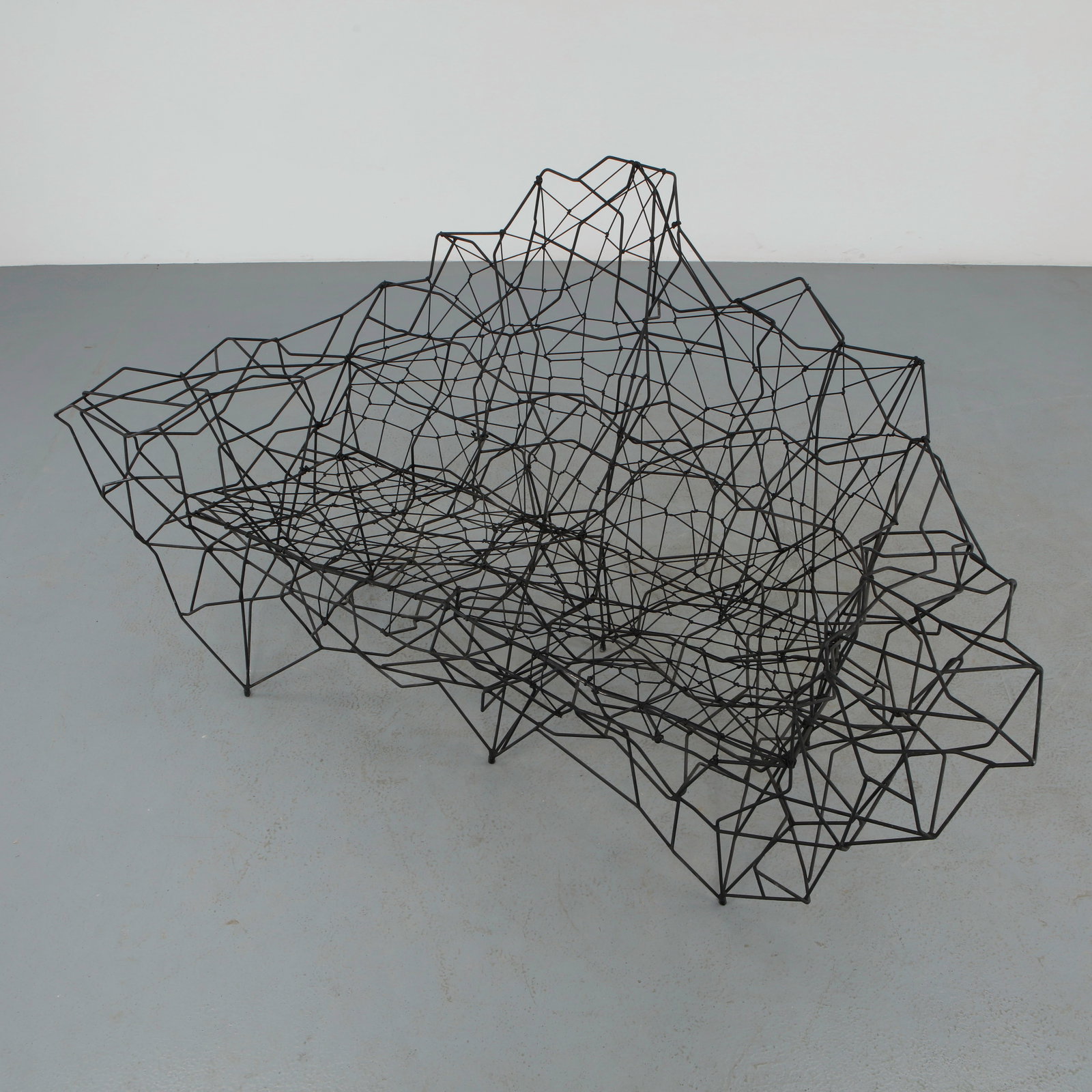 Philippe Makhloof, Sculptural Metal and Rope Sofa 1980s: Rare sculptural sofa by Philippe Makhloof executed in blackened metal with an integrated black rope seat subtly blending into the openwork structure. The dynamic silhouette reflects the artistâ€