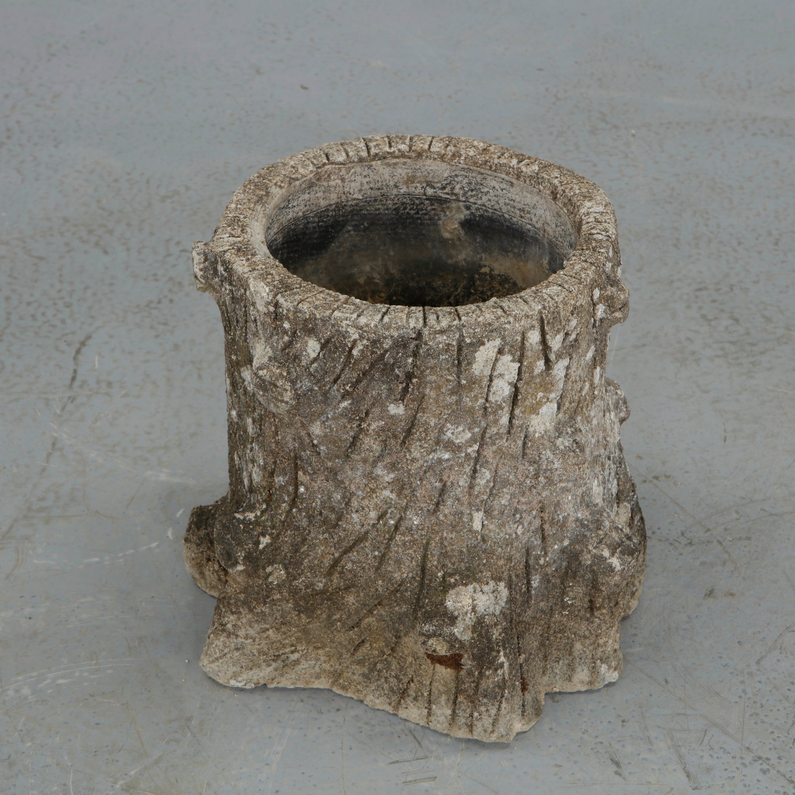 Faux Bois Round Planter, 1960s: A circular faux bois planter crafted in textured concrete, simulating the appearance of carved timber. The deep cavity and thick rim provide both function and visual weight. A timeless rustic accent