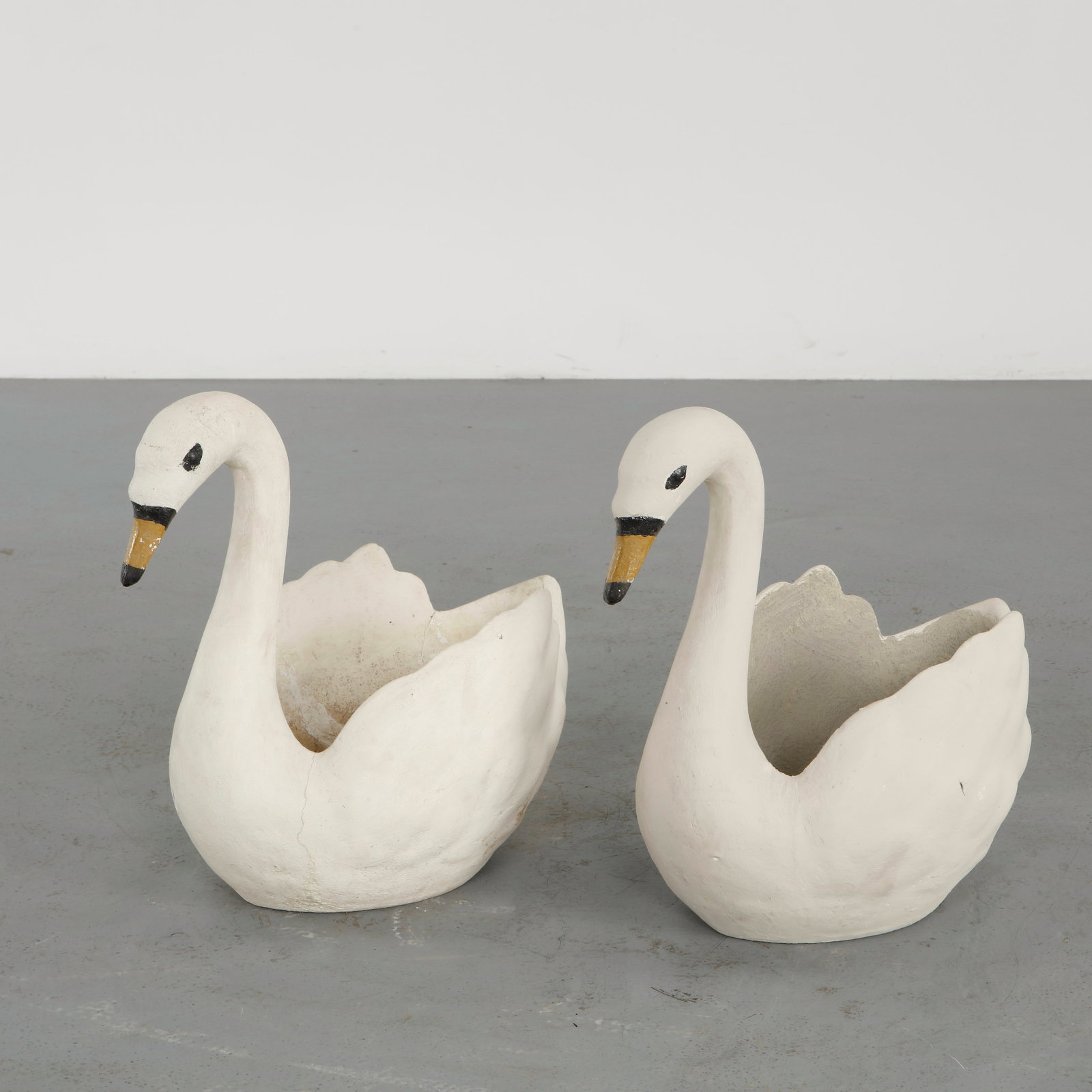 Pair of Concrete Swan Planters, 1960s: Cast in concrete and painted in white with subtle detailing, this pair of swan-shaped planters embodies playful romanticism. Their sculptural forms add both grace and nostalgia to outdoor compositions