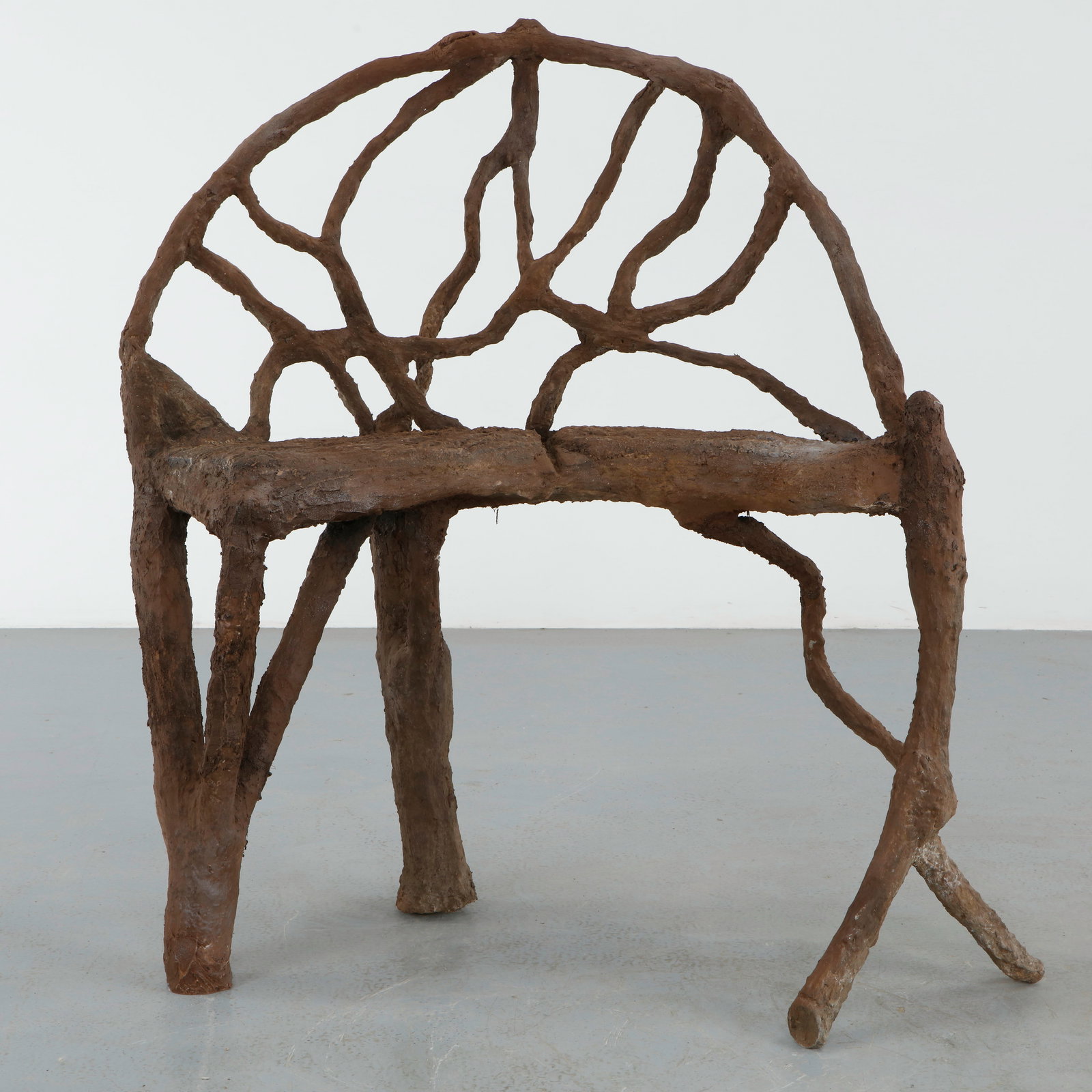 Architectural Faux Bois Bench: Architectural faux bois bench with an openwork backrest formed from branching organic lines and a restrained sculptural frame. The elongated silhouette evokes the whimsical elegance of French garden s