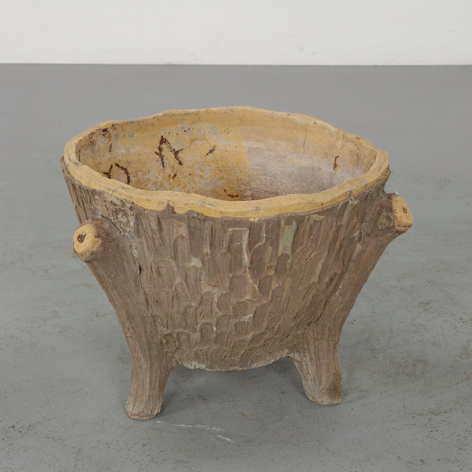 Faux Bois Concrete Planter, 1960s: Modeled to imitate natural wood, these sculptural planters showcase detailed texture and organic form. The hand finished surfaces exhibit a nuanced patina, reinforcing their rustic charm. A decorative
