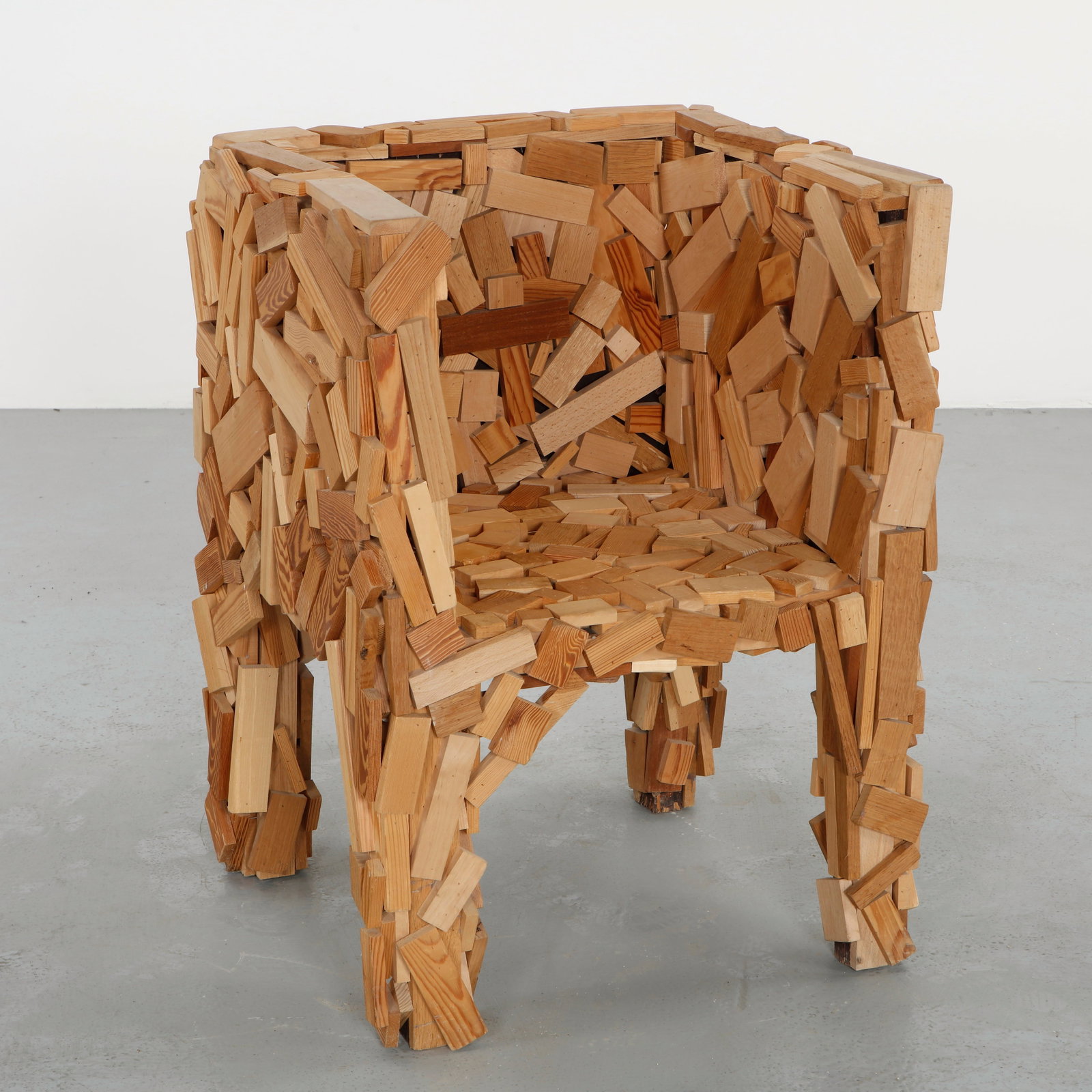 Wood Armchair in the style of Fernando and Humberto Campana, 1991: Constructed from hundreds of small reclaimed wood slats, this armchair embodies the intuitive building logic that inspired the Favela model. Each element is individually nailed and assembled by hand, 