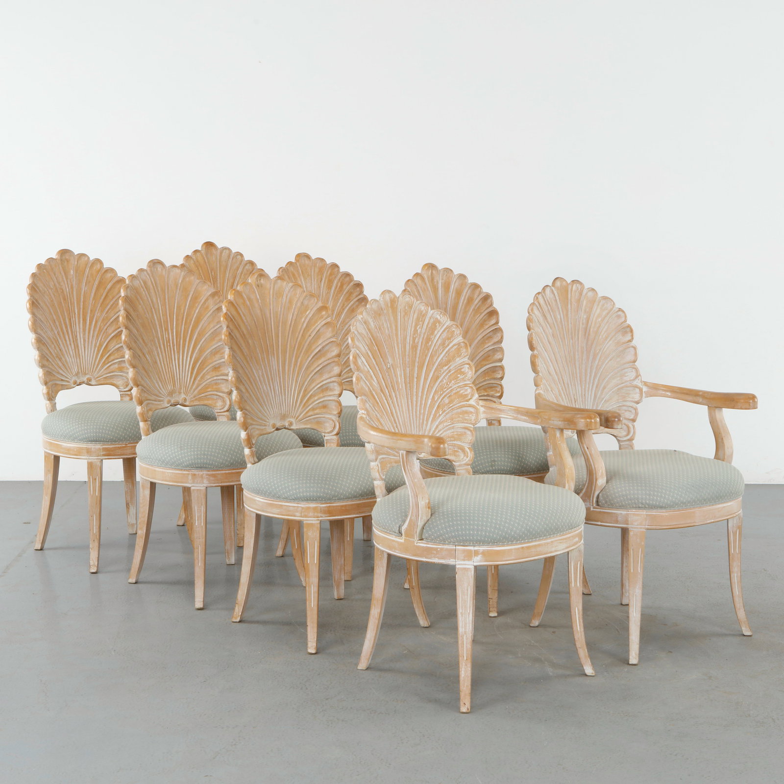 Set of 8 Venetian Grotto Style Scalloped Shell Back Dining Chairs: Elegant set of eight dining chairs featuring sculptural shell form backs with carved ribbed detailing and a softly distressed finish. The ensemble includes two armchairs and six side chairs, upholster