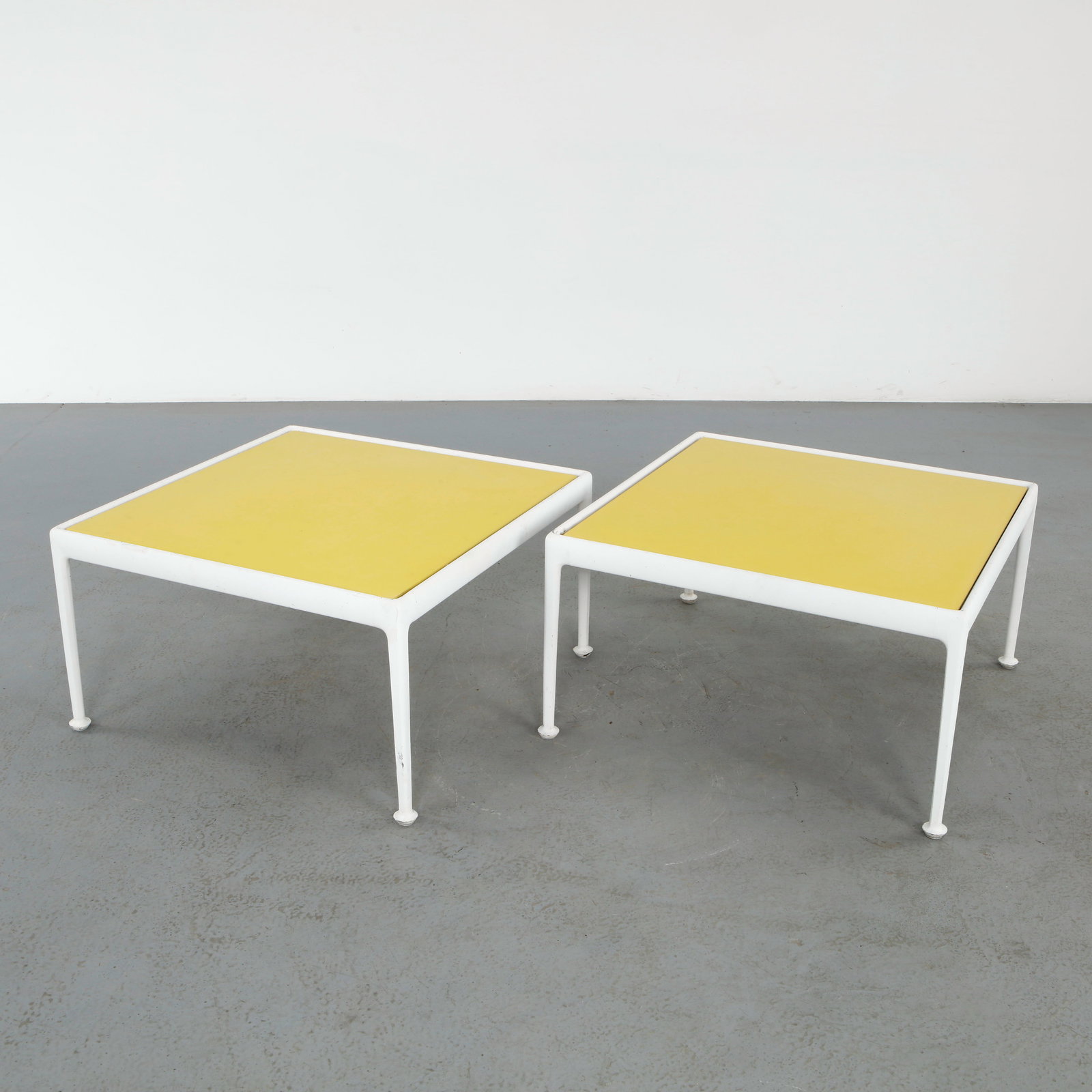 Richard Schultz for Knoll, Pair of Coffee Tables, 1970s: Constructed with white enameled frames supporting vibrant yellow tops, designed for indoor and outdoor versatility. A clean and durable design reflecting Schultz refined modernist approach. Height: