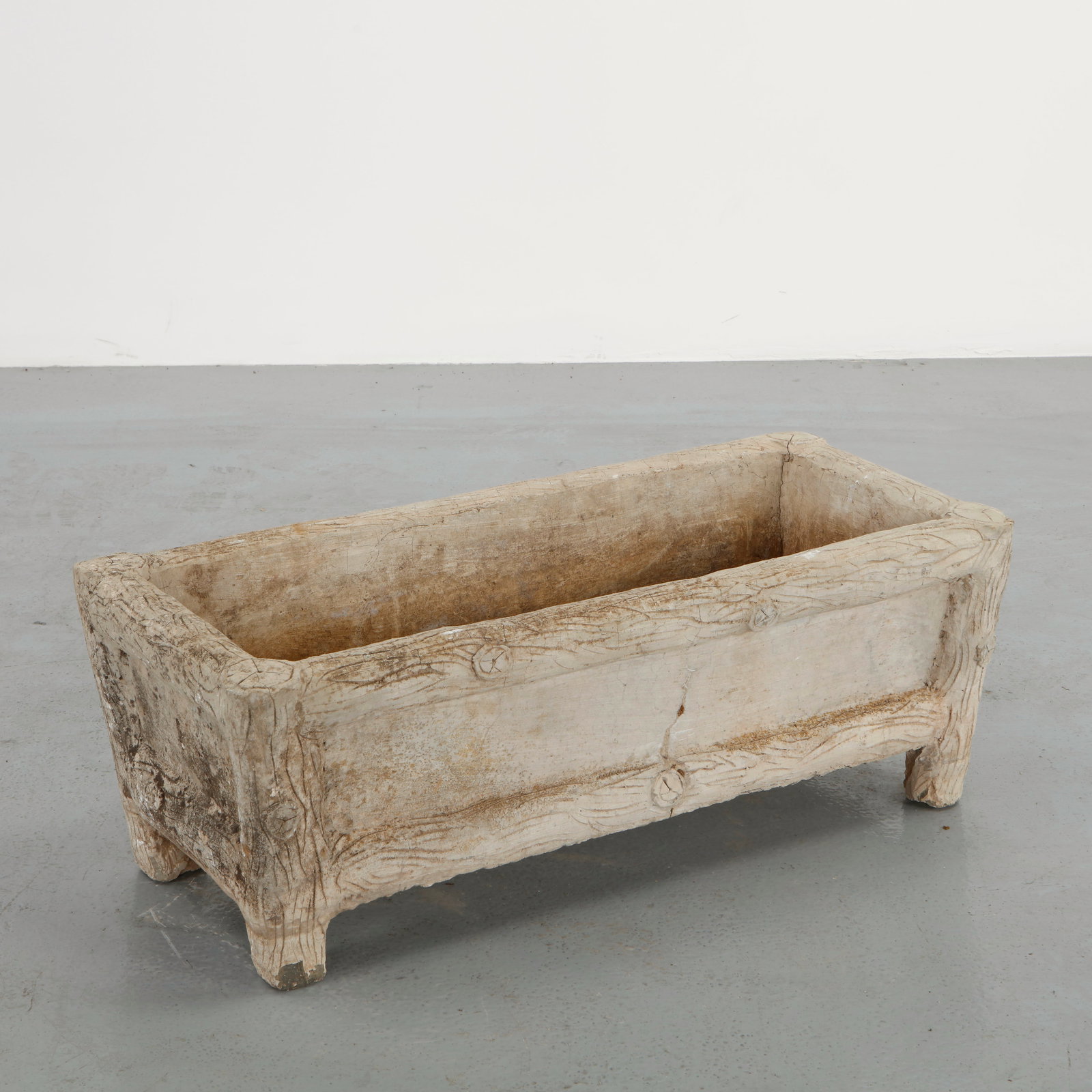 Rectangular Faux Bois Planter, 1960s: Rectangular planter in cast concrete executed in the faux bois tradition with carved wood grain detailing. The sturdy feet and thick walls emphasize its rustic handcrafted character. A timeless