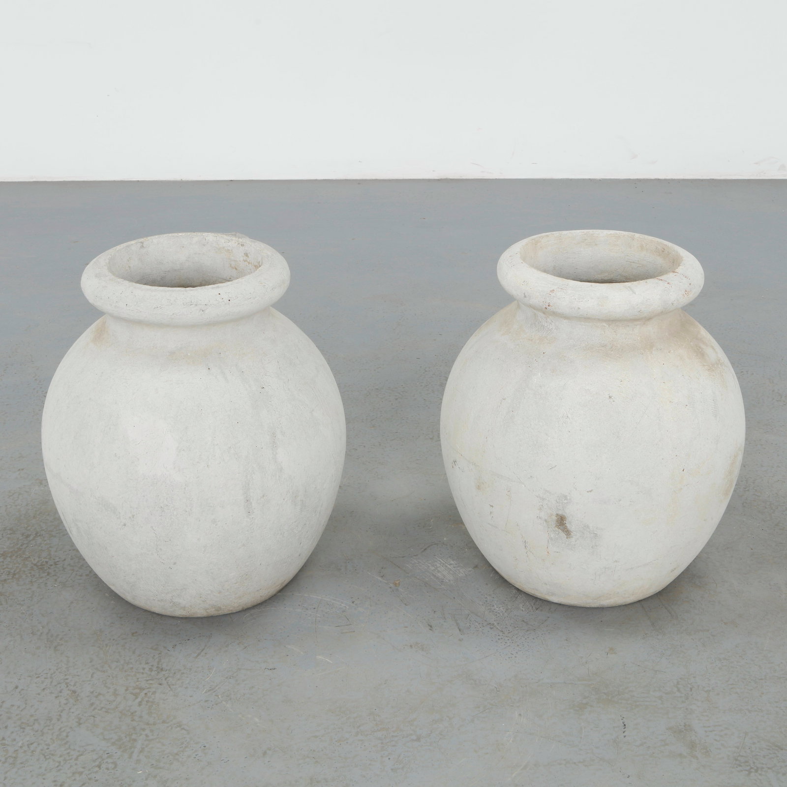 Willy Guhl, Pair of Urn Planters, 1960s: Pair of urn shaped planters designed by Willy Guhl and produced by Eternit in fiber cement. The classical silhouette is reinterpreted through Guhl restrained modernist vocabulary, while the surfaces d