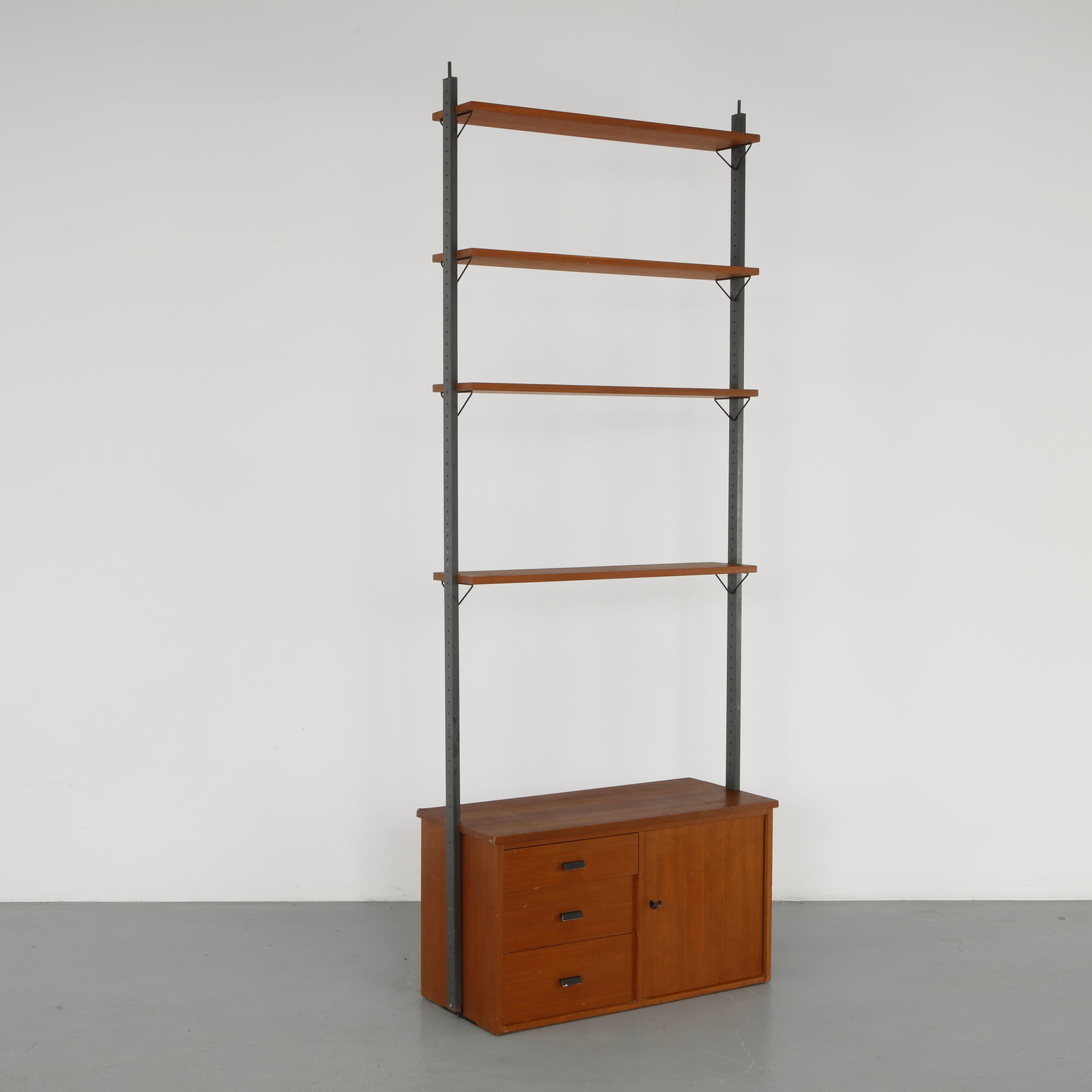Poul Cadovius, Modular Shelving Unit, 1960s: Elegant modular shelving system executed in warm-toned wood with adjustable elements, reflecting Cadovius pioneering approach to wall-mounted storage. A refined example of Danish functionalism combini