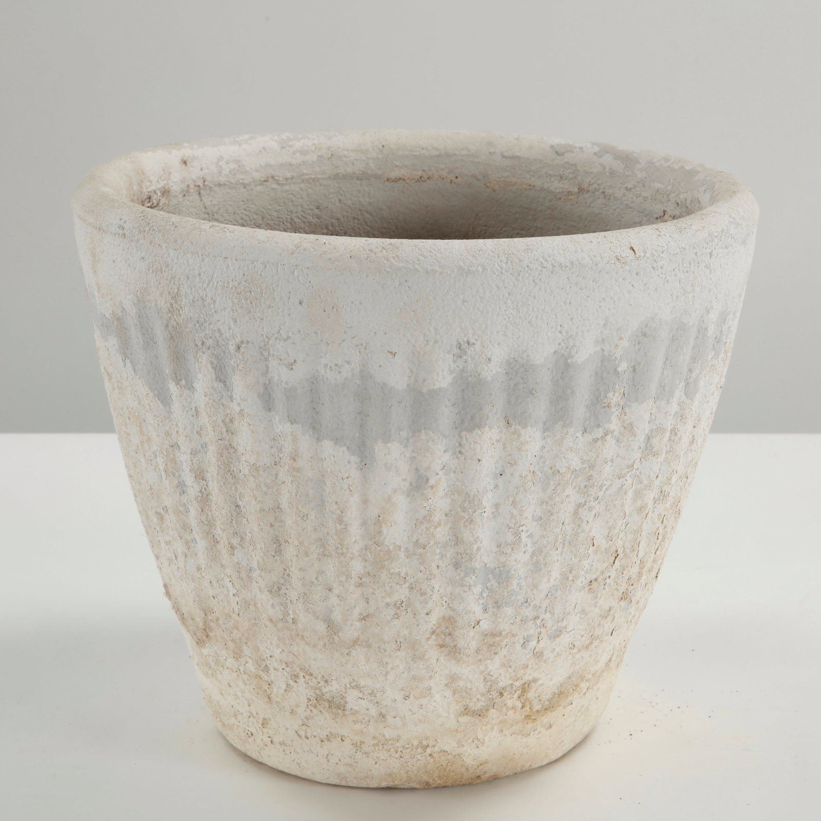 White Cast Stone Planter, 1960s: White cast stone planter with a gently flared cylindrical form and subtly textured surface. Executed in cast stone, featuring a naturally aged patina that underscores its sculptural, timeless