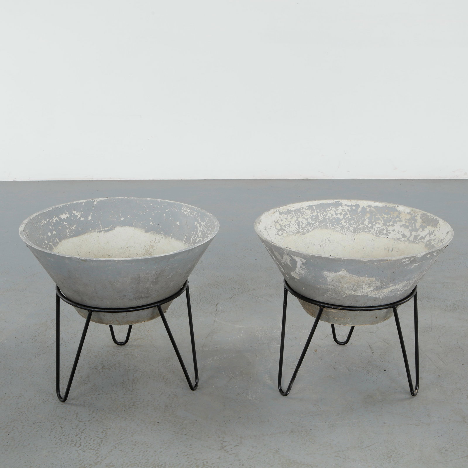 Willy Guhl, Pair of Conical Planters on Metal Stands, 1960s: Iconic Willy Guhl silhouettes in compact form, these conical planters rest atop minimalistic metal stands, weathered yet timeless Height: 19.5 in. Diameter: 22 in.