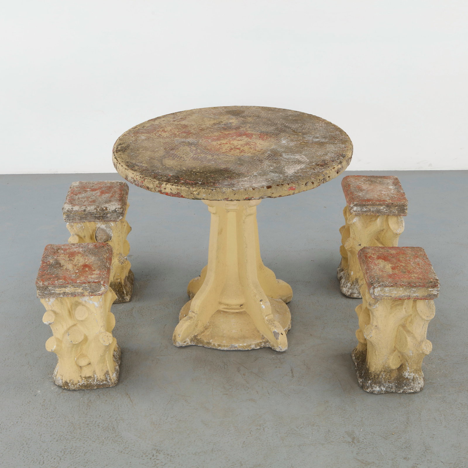 Cast Stone Garden Dining Set with Book Form Stools, 1960s: Rare faux bois garden dining set composed of a circular cast stone pedestal table and four sculptural stools featuring whimsical book form seats. Executed with deeply carved organic textures and a nat