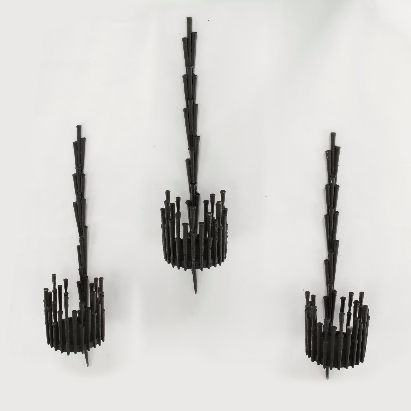 Brutalist Wall Sculpture in the style of David Palombo, 1970s: Striking brutalist wall sculpture executed in darkened metal with vertically clustered tubular elements forming an expressive architectural composition. The rhythmic industrial structure and hand