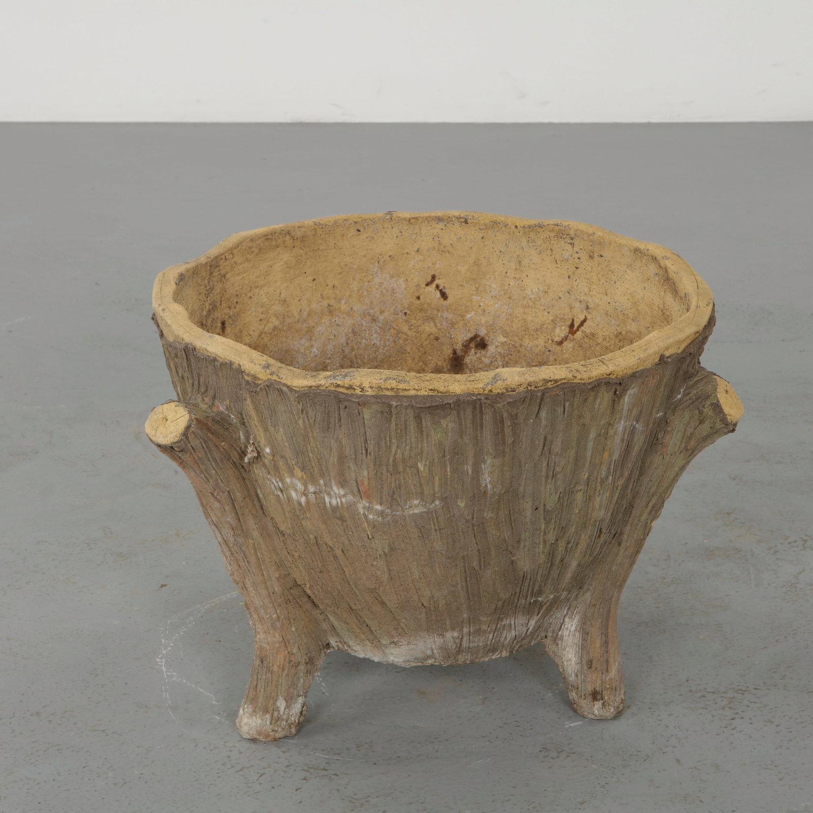 Faux Bois Concrete Planter, 1960s: Modeled to imitate natural wood, these sculptural planters showcase detailed texture and organic form. The hand finished surfaces exhibit a nuanced patina, reinforcing their rustic charm. A decorative