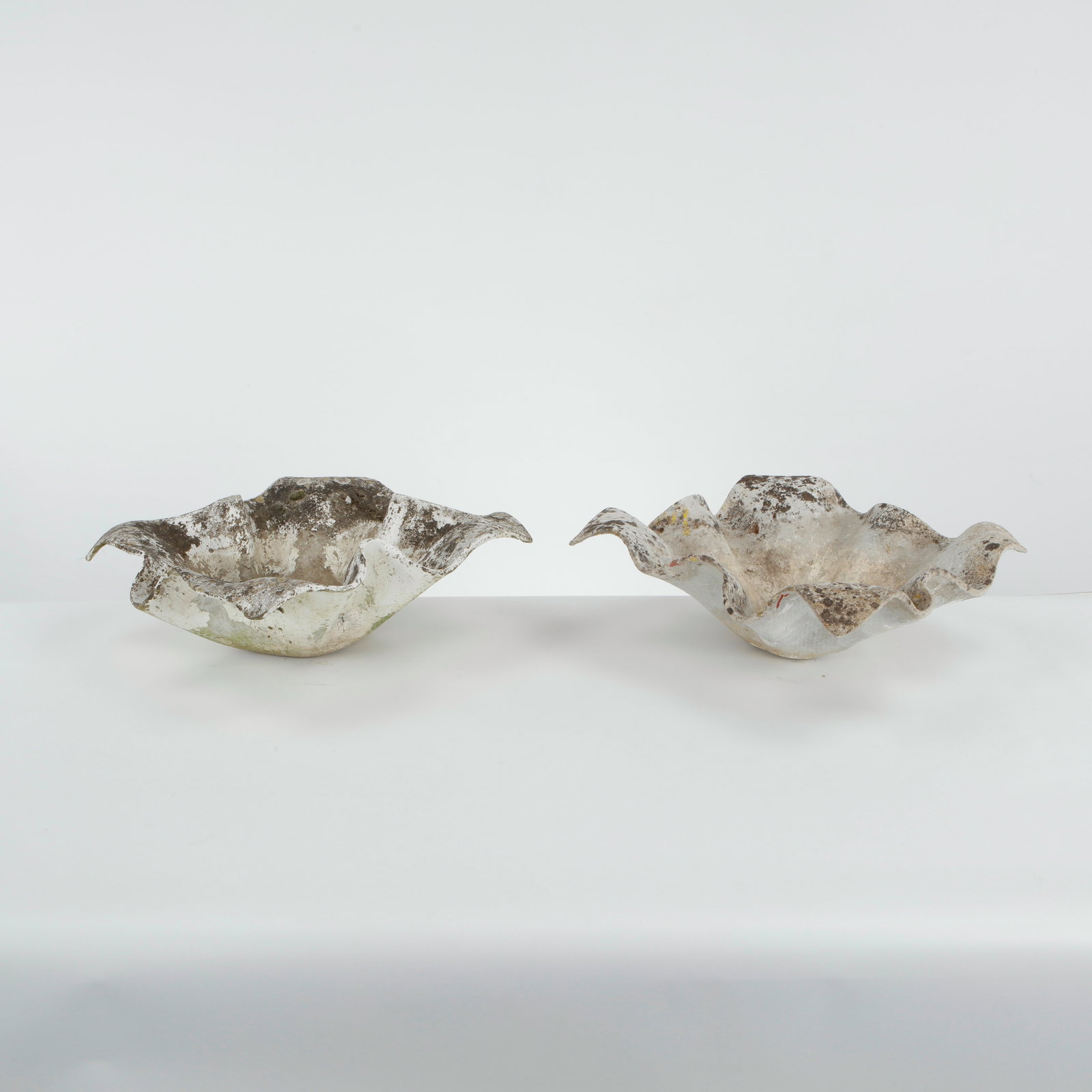 Willy Guhl, Pair of Small Elephant Ear Planters, 1960s: Pair of Small Elephant Ear planters, also known as handkerchief planters, by Willy Guhl for Eternit, Switzerland circa 1960. Factory-drilled drainage holes. Wonderful patina. Width: 19 in. Length: 19 