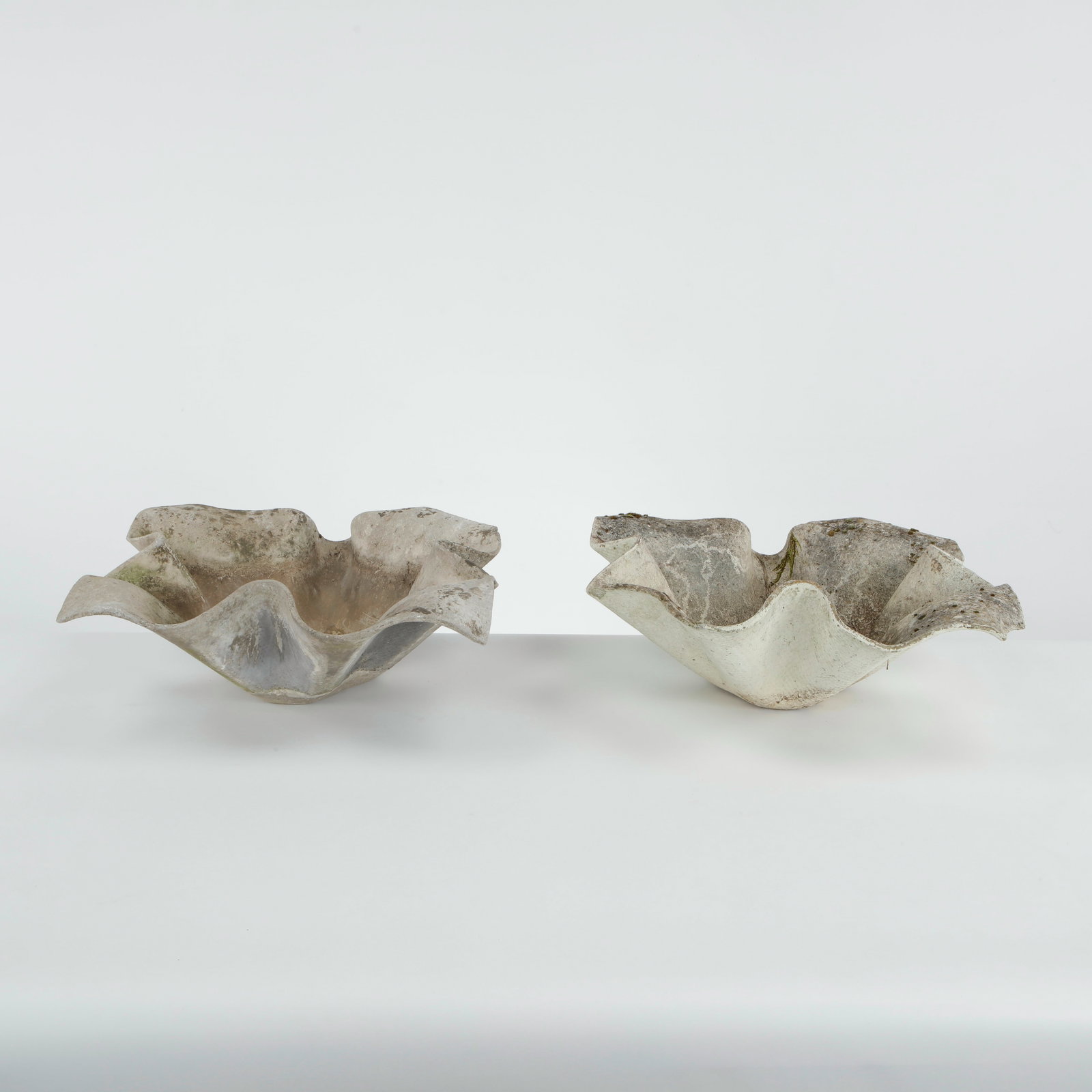 Willy Guhl, Pair of Small Elephant Ear Planters, 1960s: Pair of Small Elefantenohr Elephant Ear planters, also known as handkerchief planters, by Willy Guhl for Eternit, Switzerland circa 1960. Factory-drilled drainage holes. Wonderful patina. Width: 19 in