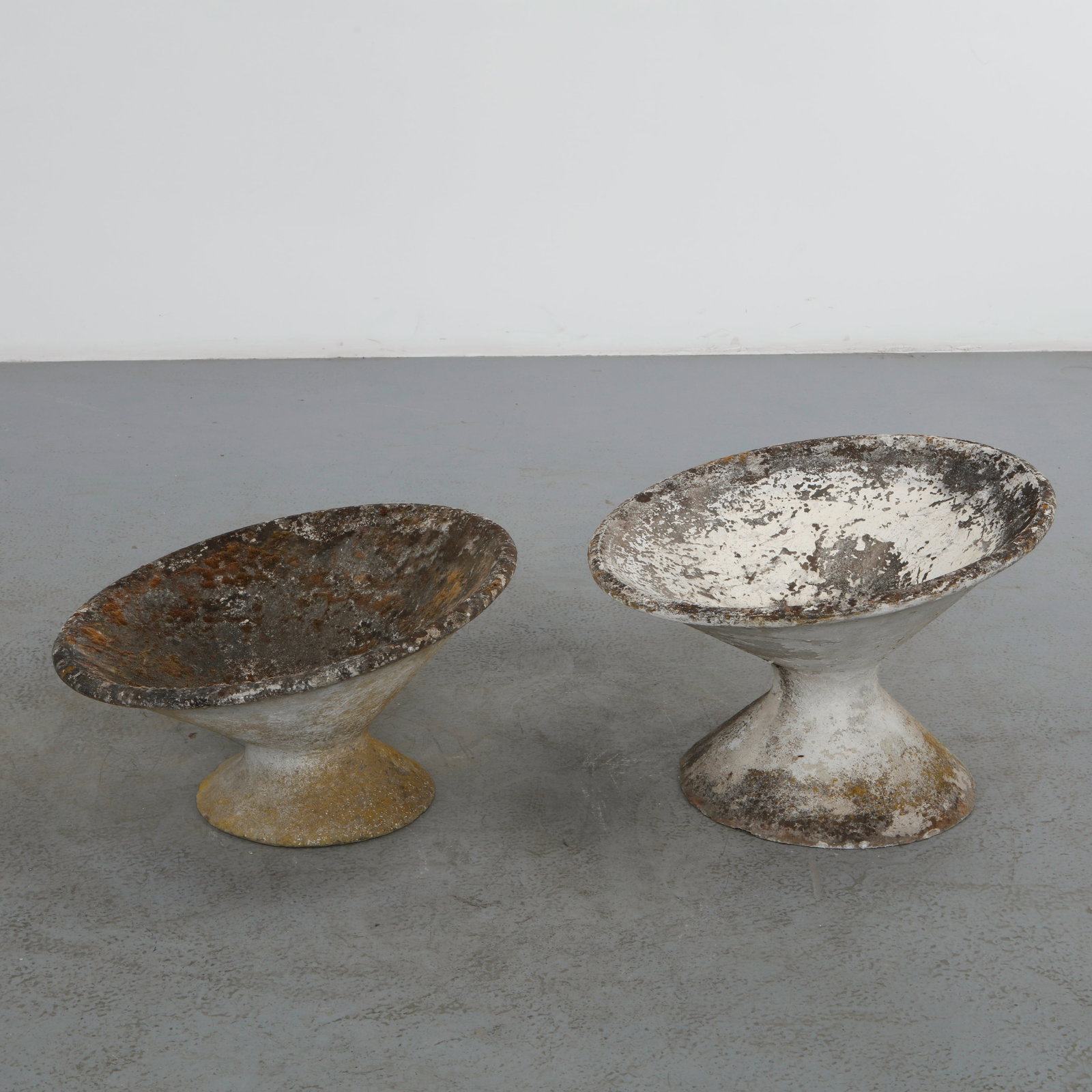 Willy Guhl, Pair of Off-Kilter Planters, 1960s: A pair of rare asymmetrical planters by Willy Guhl, featuring a bold modernist design. Height: 14.5 in. Diameter: 25 in. Taller: Height: 18.5 in. Diameter: 25 in.