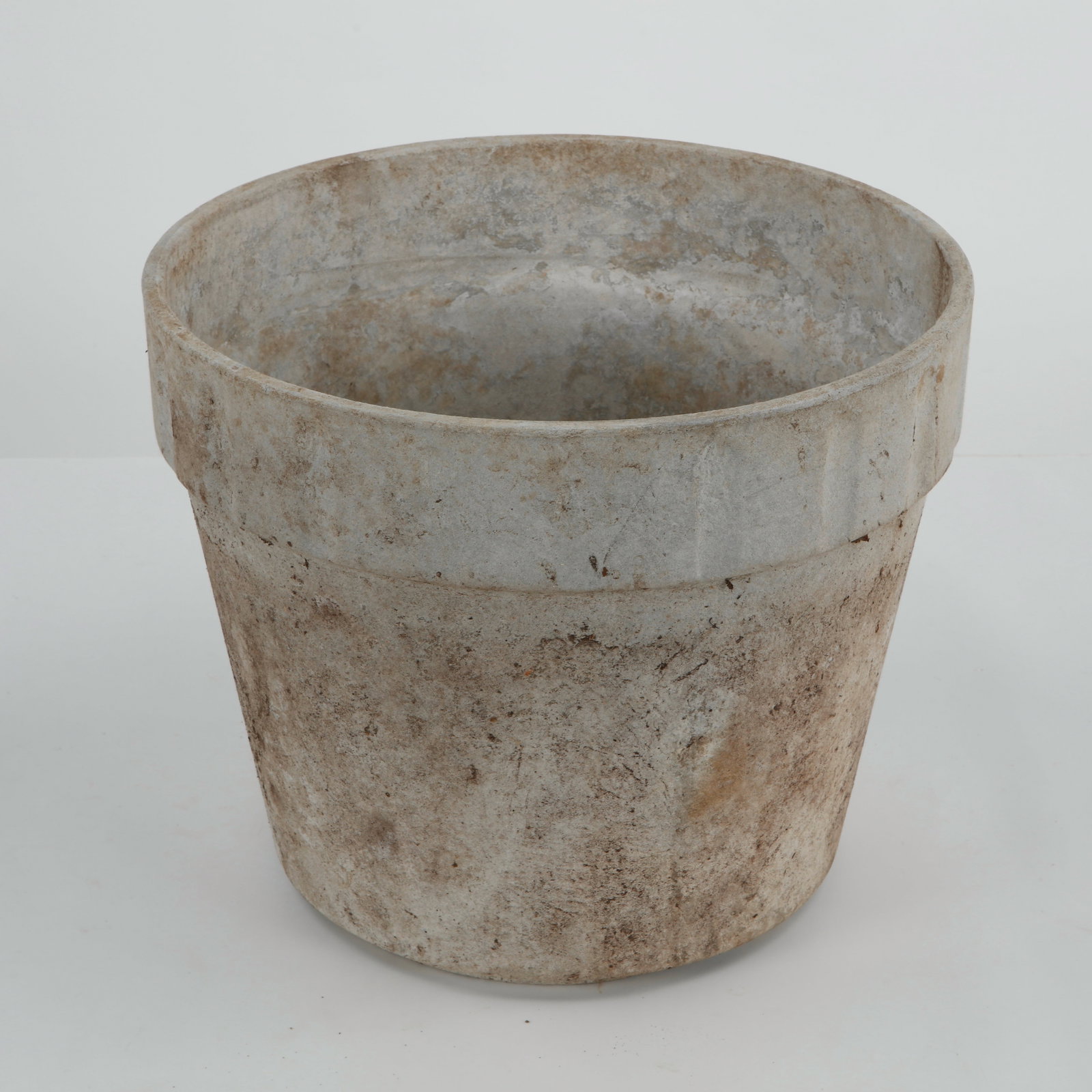 Willy Guhl, Round Planter, 1960s: Executed in fiber cement with a refined cylindrical form, this planter exemplifies Willy Guhl restrained modernist aesthetic. Its sculptural silhouette and natural weathered patina make it an elegant 