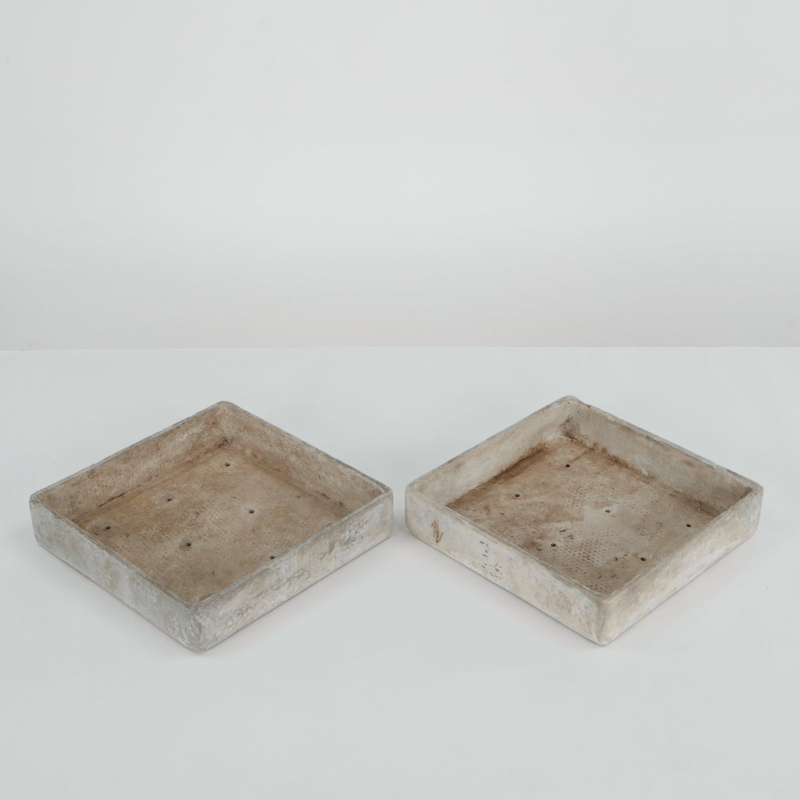 Willy Guhl, Pair of Square Tray Planters, 1960s: Rare pair of square Eternit tray planters designed by Willy Guhl, executed in fiber cement with clean geometric proportions and softened edges. Their restrained architectural form and naturally weathe