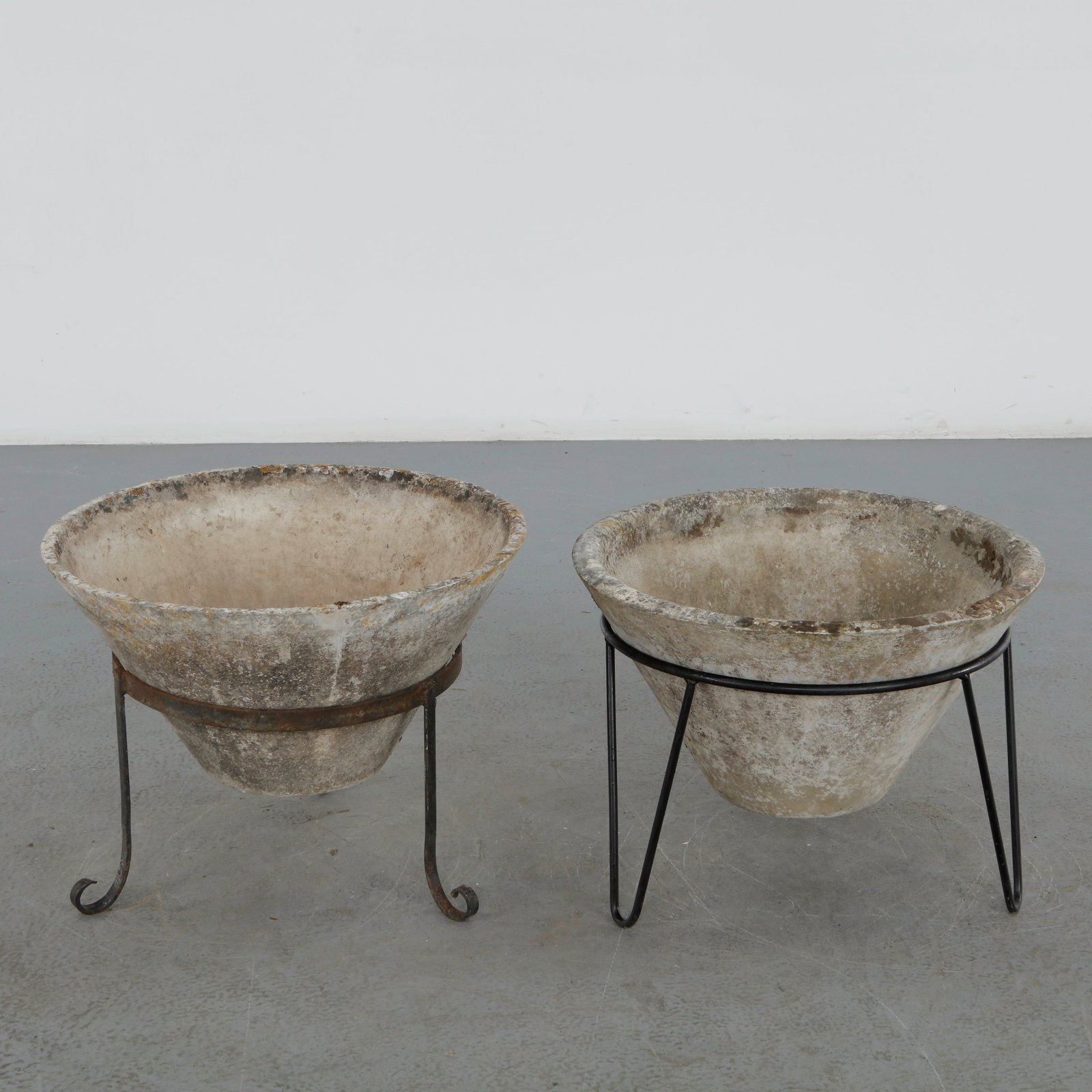 Willy Guhl, Pair of Conical Planters on Stands, 1960s: An exceptional pair of Willy Guhl conical planters in fiber cement, retaining their original steel stands. Their restrained geometry, sculptural presence, and richly weathered finish make them outstan